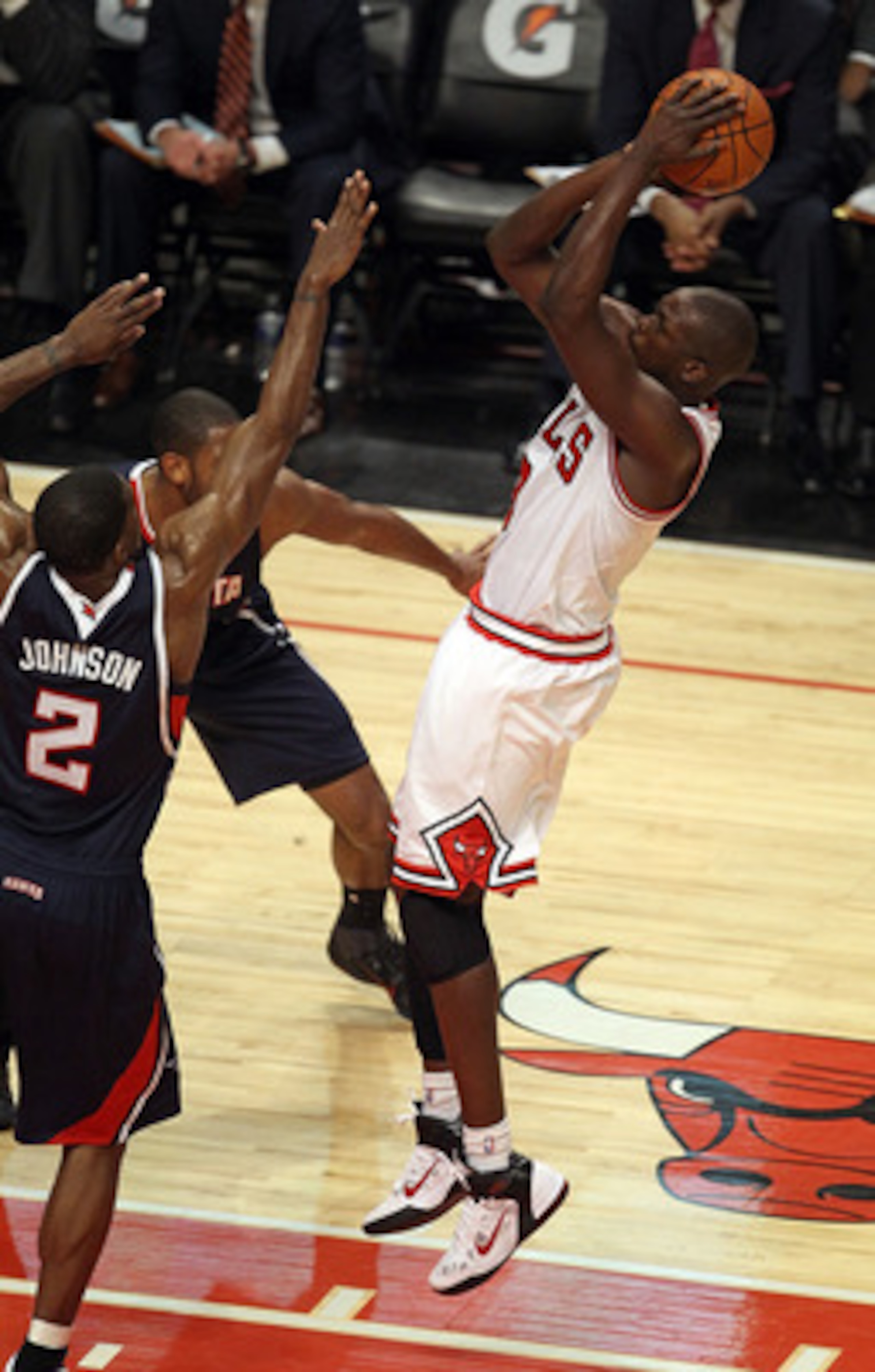 CHICAGO, IL - MARCH 11: Loul Deng #9 of the Chicago Bulls puts up a shot over Joe Johnson #2 of the Atlanta Hawks at the United Center on March 11, 2011 in Chicago, Illinois. The Bulls defeated the Hawks 94-76. NOTE TO USER: User expressly acknowledges an