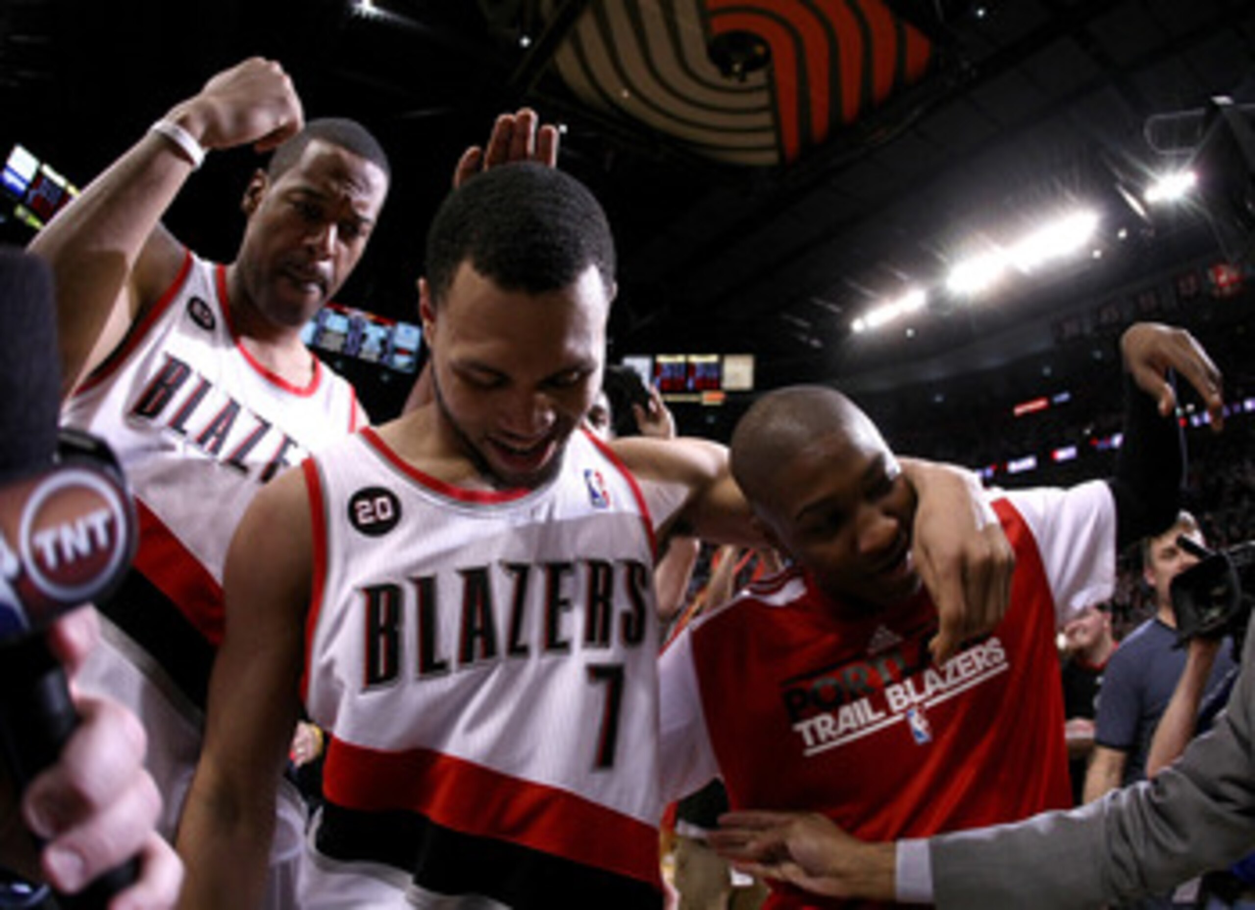 PORTLAND, OR - APRIL 23:  Brandon Roy #7 of the Portland Trail Blazers celebrates with teammates Marcus Camby #23 and Armon Johnson #1 after overcoming a 23 point deficit to defeat the of the Dallas Mavericks 84-82 in Game Four of the Western Conference Q