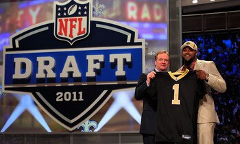 NEW YORK, NY - APRIL 28:  NFL Commissioner Roger Goodell (L) poses for a photo with Cameron Jordan, #24 overall pick by the New Orleans Saints, holds up a jersey on stage during the 2011 NFL Draft at Radio City Music Hall on April 28, 2011 in New York Cit
