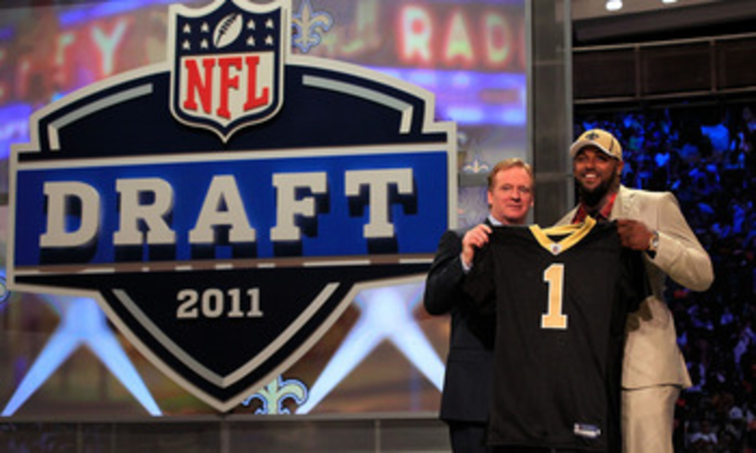 NEW YORK, NY - APRIL 28: NFL Commissioner Roger Goodell (L) poses for a photo with Cameron Jordan, #24 overall pick by the New Orleans Saints, holds up a jersey on stage during the 2011 NFL Draft at Radio City Music Hall on April 28, 2011 in New York Cit NEW YORK, NY - APRIL 28: NFL Commissioner Roger Goodell (L) poses for a photo with Cameron Jordan, #24 overall pick by the New Orleans Saints, holds up a jersey on stage during the 2011 NFL Draft at Radio City Music Hall on April 28, 2011 in New York Cit