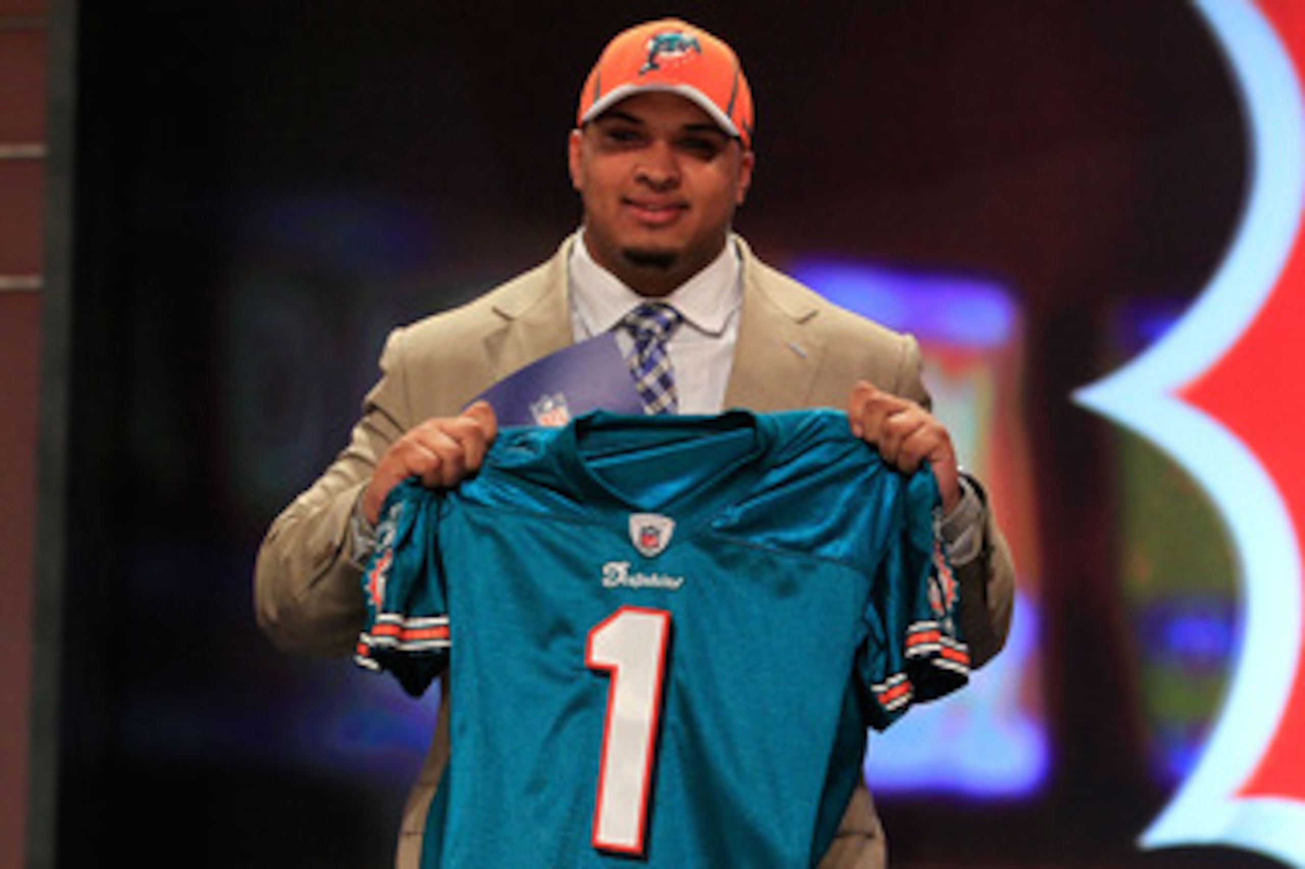 NEW YORK, NY - APRIL 28:  Mike Pouncey, #15 overall pick by the Miami Dolphins, holds up a jersey on stage during the 2011 NFL Draft at Radio City Music Hall on April 28, 2011 in New York City.  (Photo by Chris Trotman/Getty Images)