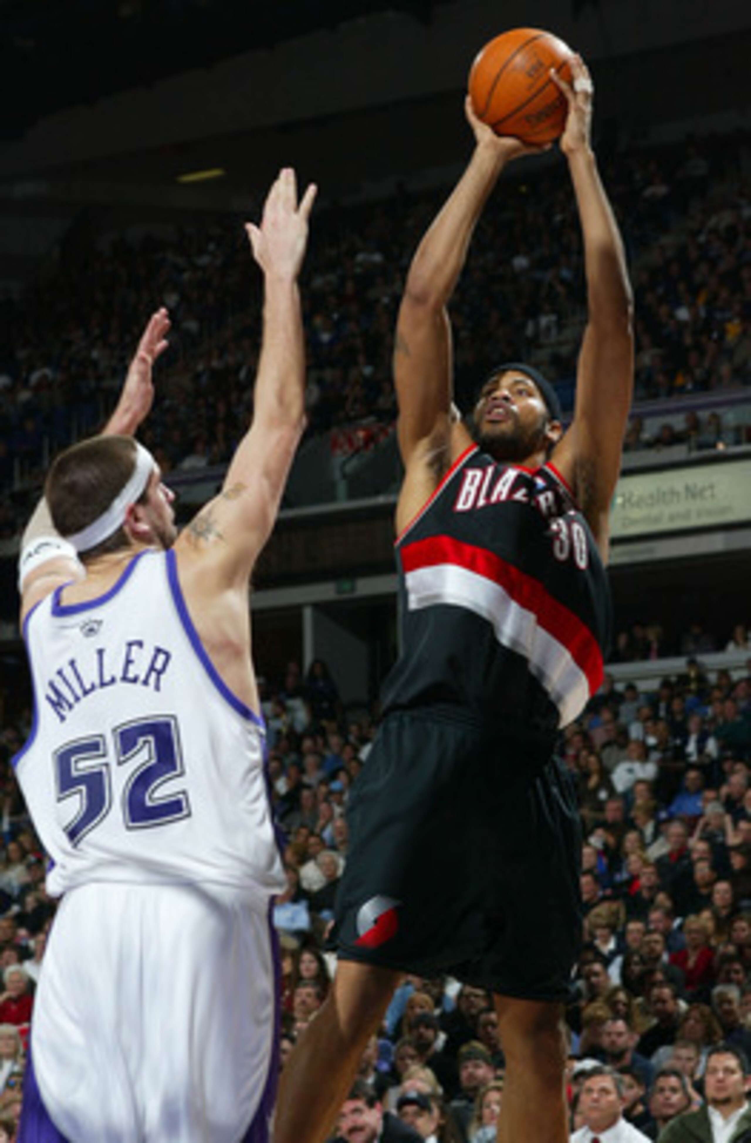 SACRAMENTO, CA - JANUARY 20:  Rasheed Wallace #30 of the Portland Trail Blazers shoots over Brad Miller #52 of the Sacramento Kings during an NBA game on January 20, 2004 at Arco Arena in Sacramento, California.  NOTE TO USER: User expressly acknowledges