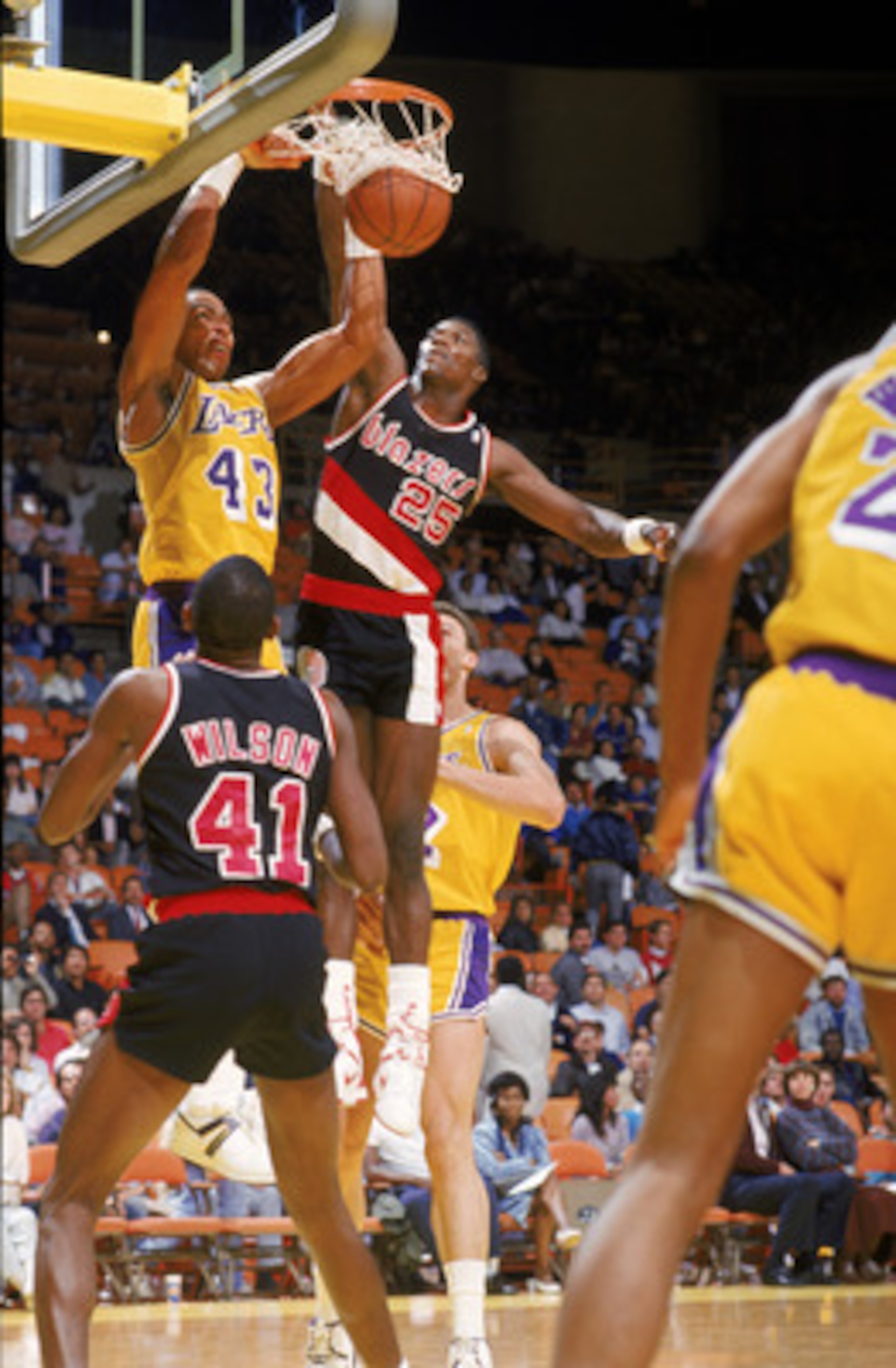 LOS ANGELES - 1987:  Mychal Thompson #43 of the Los Angeles Lakers dunks over Jerome Kersey #25 of the Portland Trail Blazers during an NBA game at the Great Western Forum in Los Angeles, California in 1987. (Photo by: Mike Powell/Getty Images)