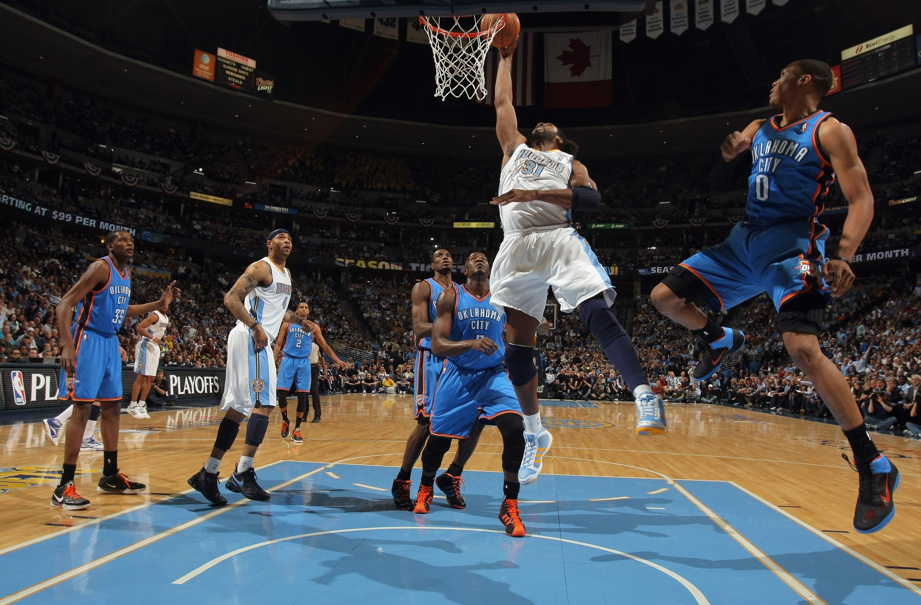 DENVER, CO - APRIL 23:  Nene Hilario #31 of the Denver Nuggets takes a shot between Kendrick Perkins #5 and Russell Westbrook #0 of the Oklahoma City Thunder in Game Three of the Western Conference Quarterfinals in the 2011 NBA Playoffs on April 23, 2011
