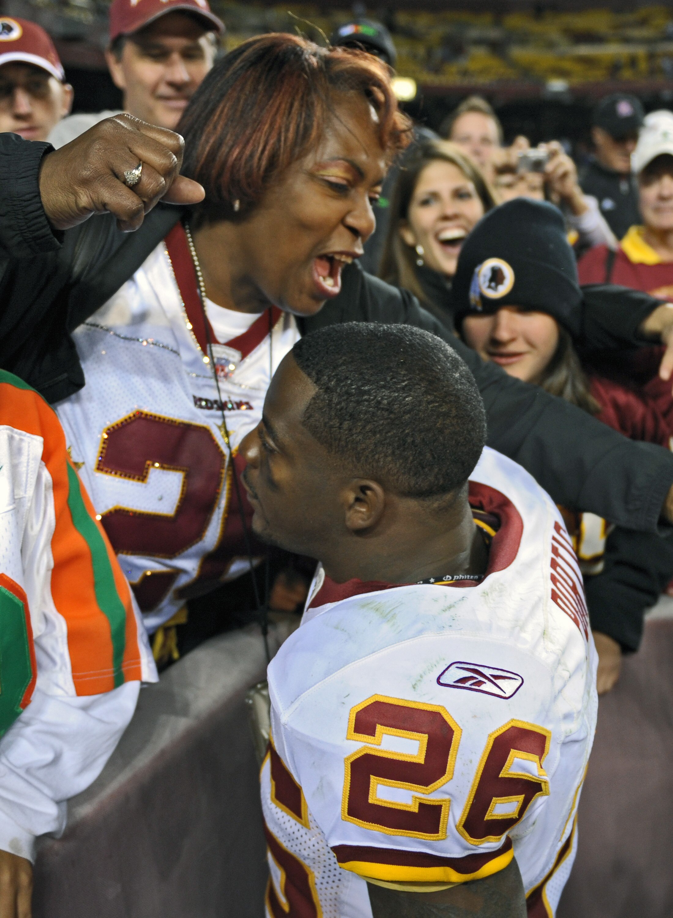 LANDOVER, MD - OCTOBER 19: Running back Clinton Portis #26 of the Washington Redskins is greeted by his mother Rhonnel Hearns after the game against the Cleveland Browns on October 19, 2008 at FedEx Field in Landover, Maryland. (Photo by Drew Hallowell/Ge