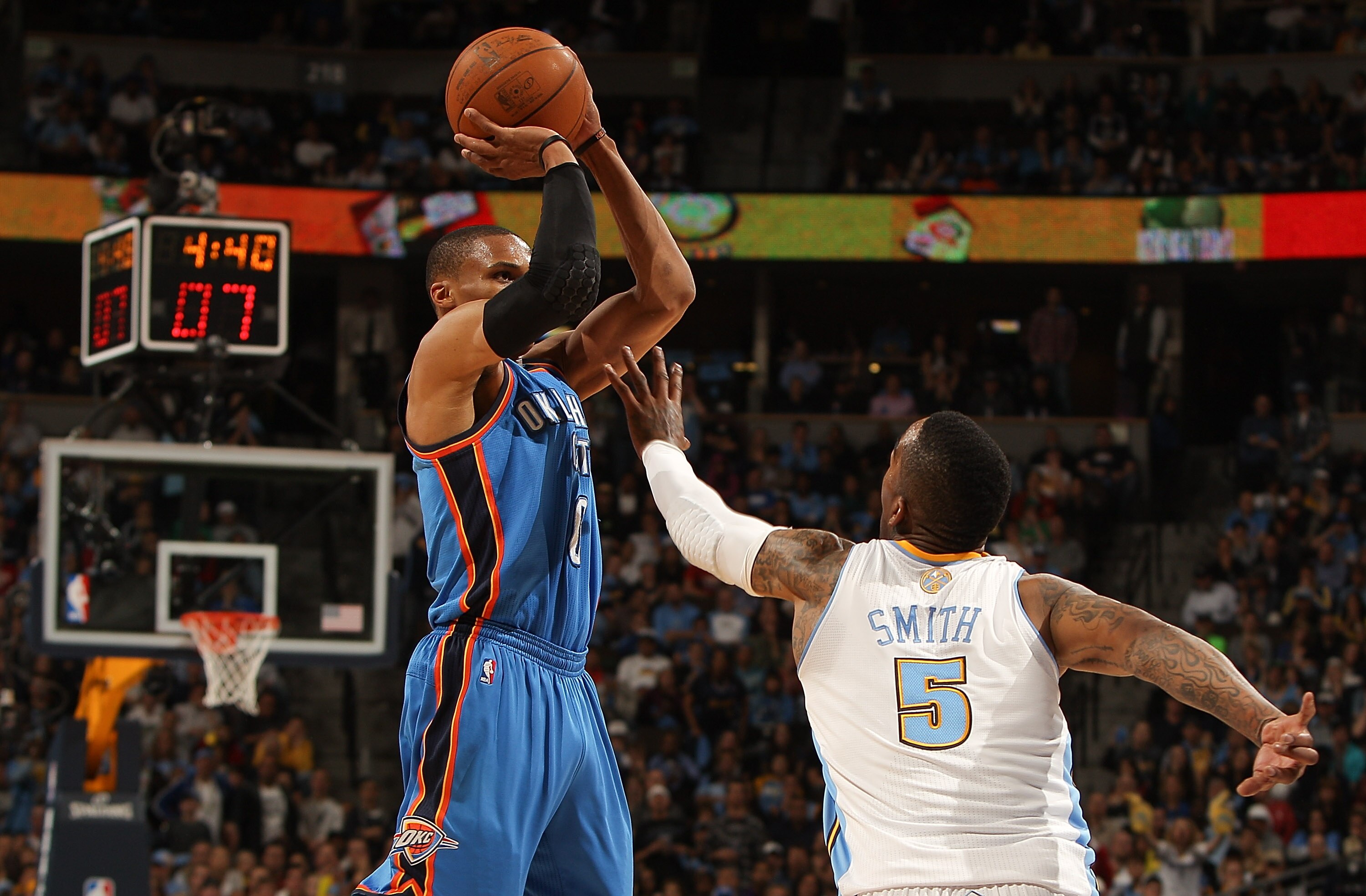 DENVER, CO - APRIL 25:  Russell Westbrook #0 of the Oklahoma City Thunder shoots over J.R. Smith #5 of the Denver Nuggets in Game Four of the Western Conference Quarterfinals in the 2011 NBA Playoffs at Pepsi Center on April 25, 2011 in Denver, Colorado.