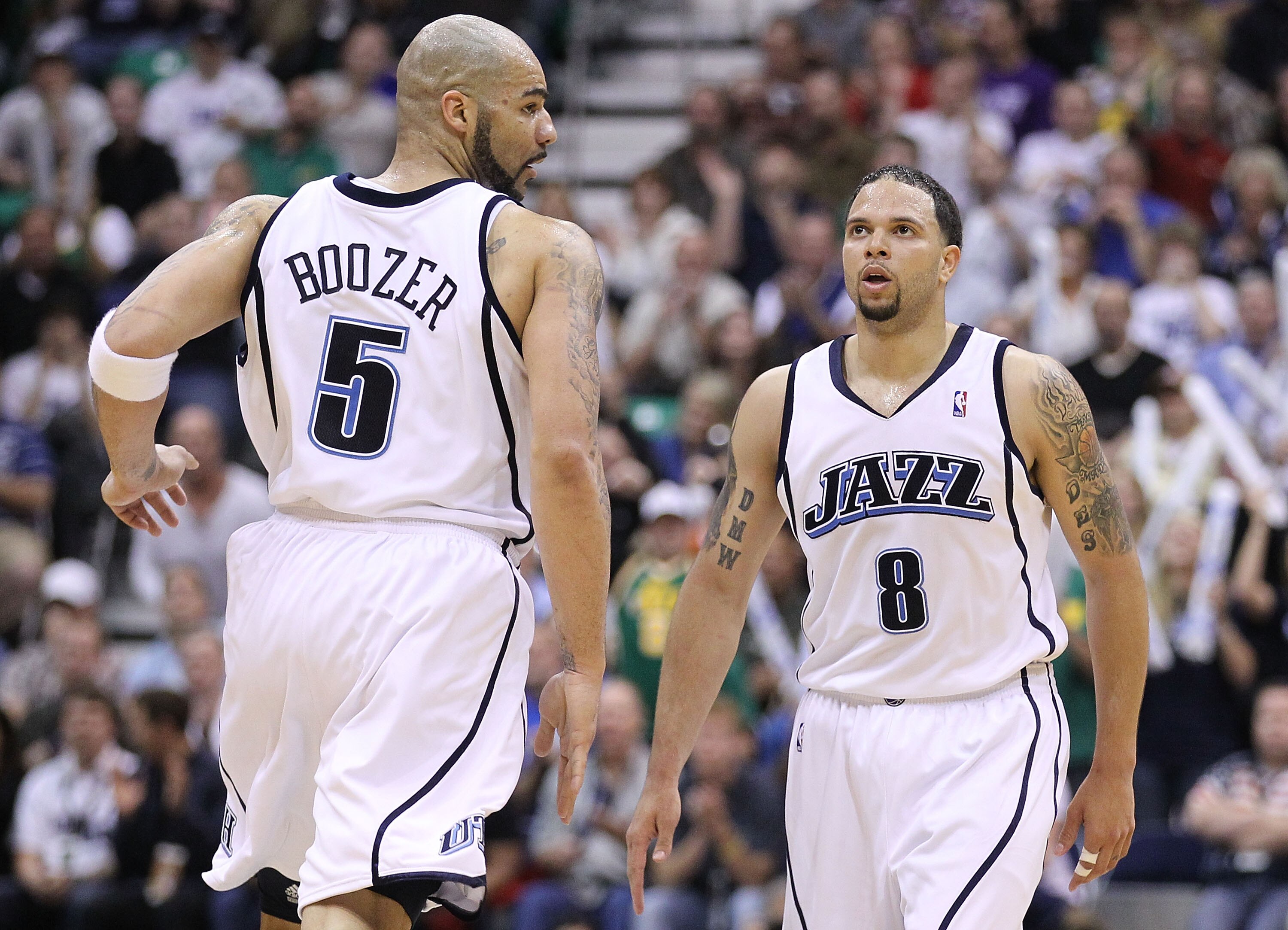 SALT LAKE CITY - MAY 10:  Deron Williams #8 and Carlos Boozer #5 of the Utah Jazz look on against the Los Angeles Lakers during Game Four of the Western Conference Semifinals of the 2010 NBA Playoffs on May 10, 2010 at Energy Solutions Arena in Salt Lake