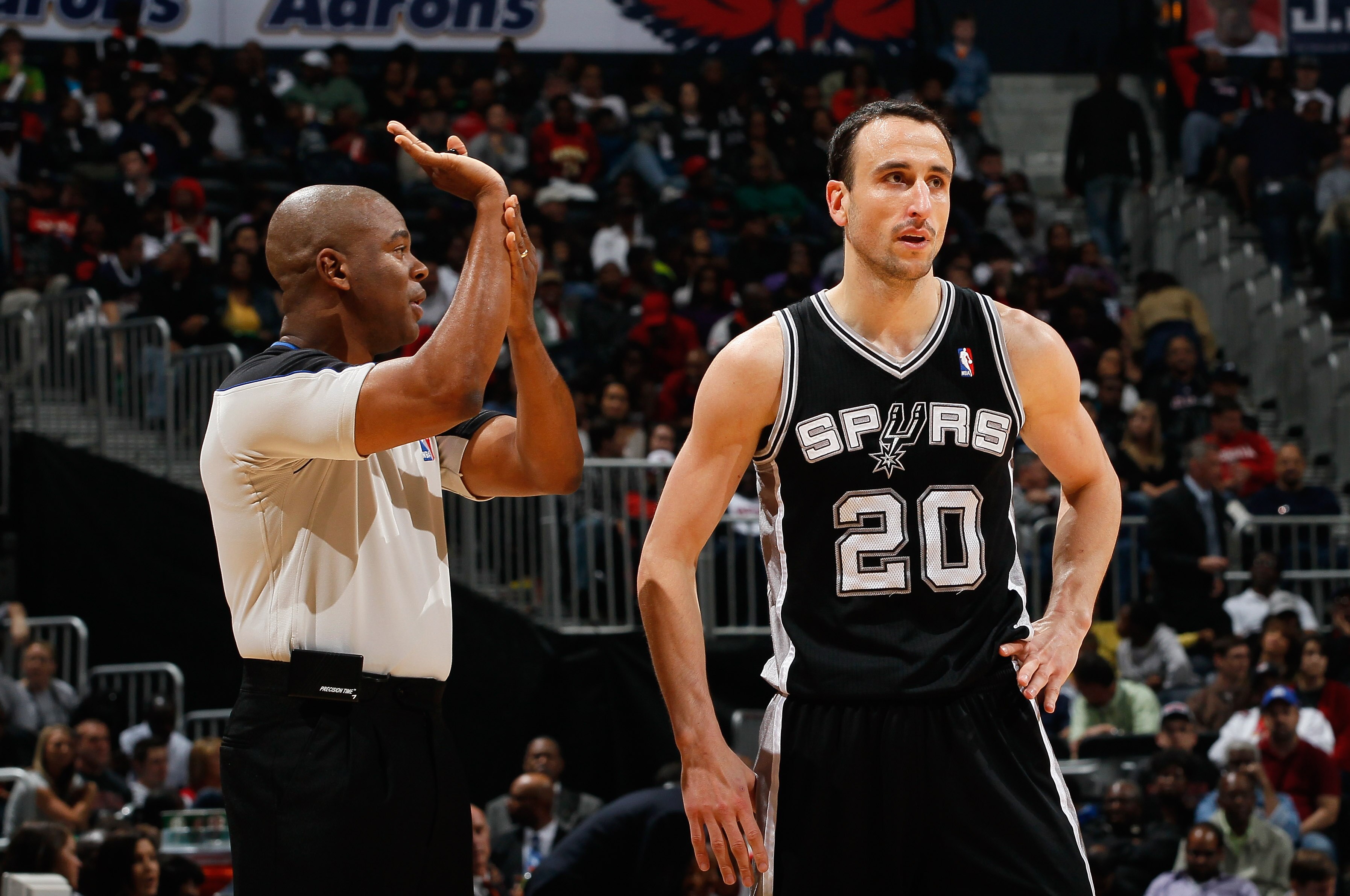 ATLANTA, GA - APRIL 05:  Manu Ginobili #20 of the San Antonio Spurs converses with referee Sean Wright #65 against the Atlanta Hawks at Philips Arena on April 5, 2011 in Atlanta, Georgia.  NOTE TO USER: User expressly acknowledges and agrees that, by down
