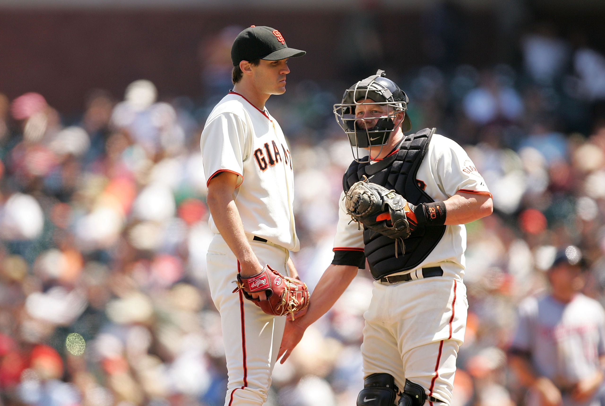 SAN FRANCISCO - MAY 13:  Catcher Steve Holm #20 pats Barry Zito #75 of the San Francisco Giants on the leg right before Zito is taken out of the game with the bases loaded in the seventh inning of their game against the Washington Nationals at AT&T Park o