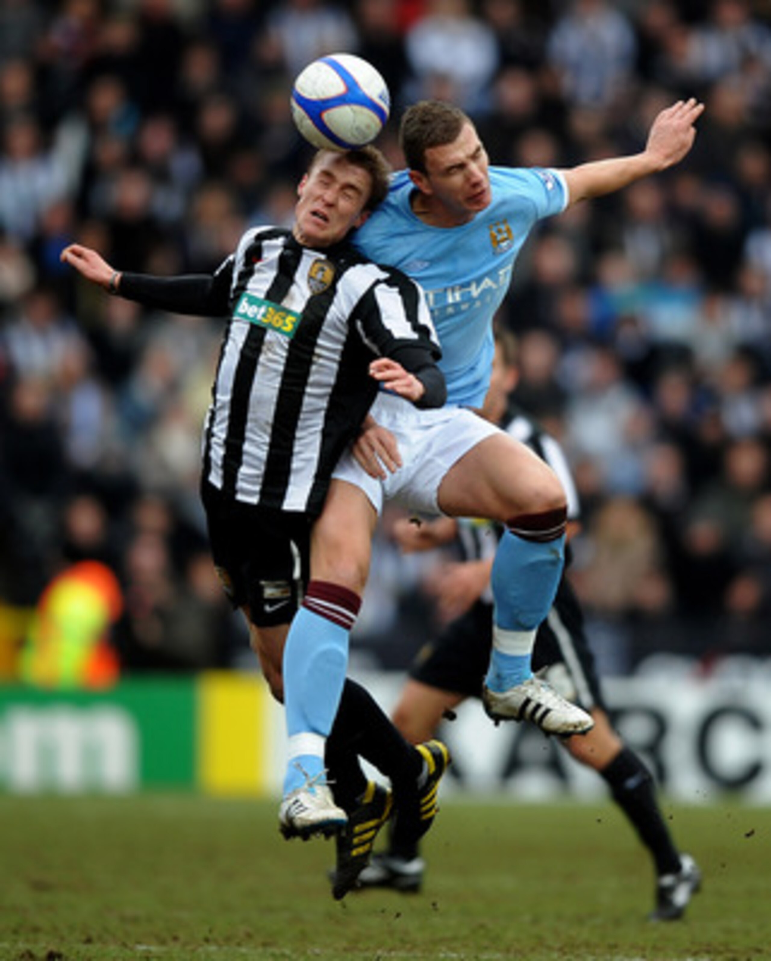 NOTTINGHAM, ENGLAND - JANUARY 30:  Stephen Darby of Notts County tangles with Edin Dzeko of Manchester City during the FA Cup sponsored by E.On 4th Round match between Notts County and Manchester City at Meadow Lane on January 30, 2011 in Nottingham, Engl