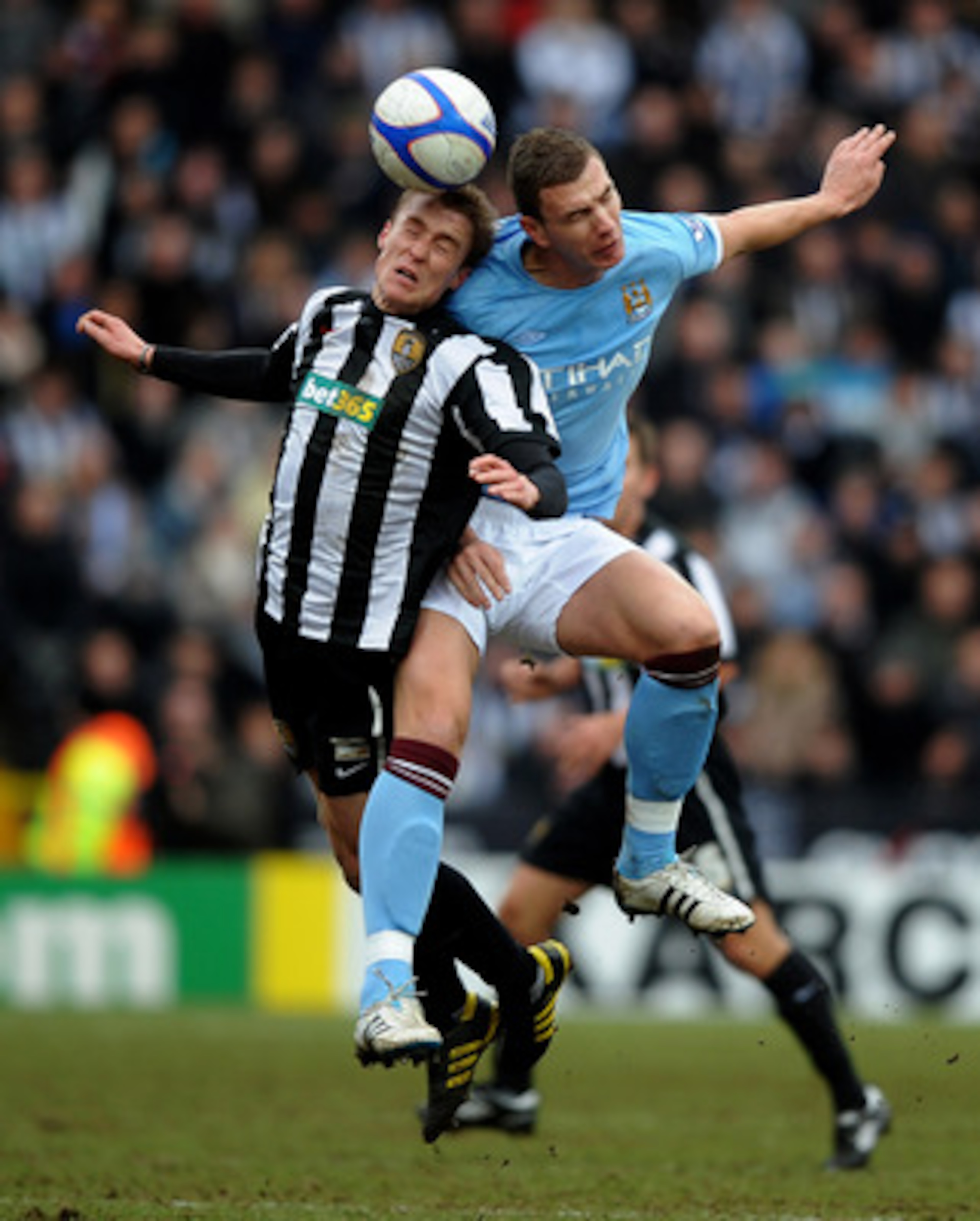 NOTTINGHAM, ENGLAND - JANUARY 30: Stephen Darby of Notts County tangles with Edin Dzeko of Manchester City during the FA Cup sponsored by E.On 4th Round match between Notts County and Manchester City at Meadow Lane on January 30, 2011 in Nottingham, Engl NOTTINGHAM, ENGLAND - JANUARY 30: Stephen Darby of Notts County tangles with Edin Dzeko of Manchester City during the FA Cup sponsored by E.On 4th Round match between Notts County and Manchester City at Meadow Lane on January 30, 2011 in Nottingham, Engl