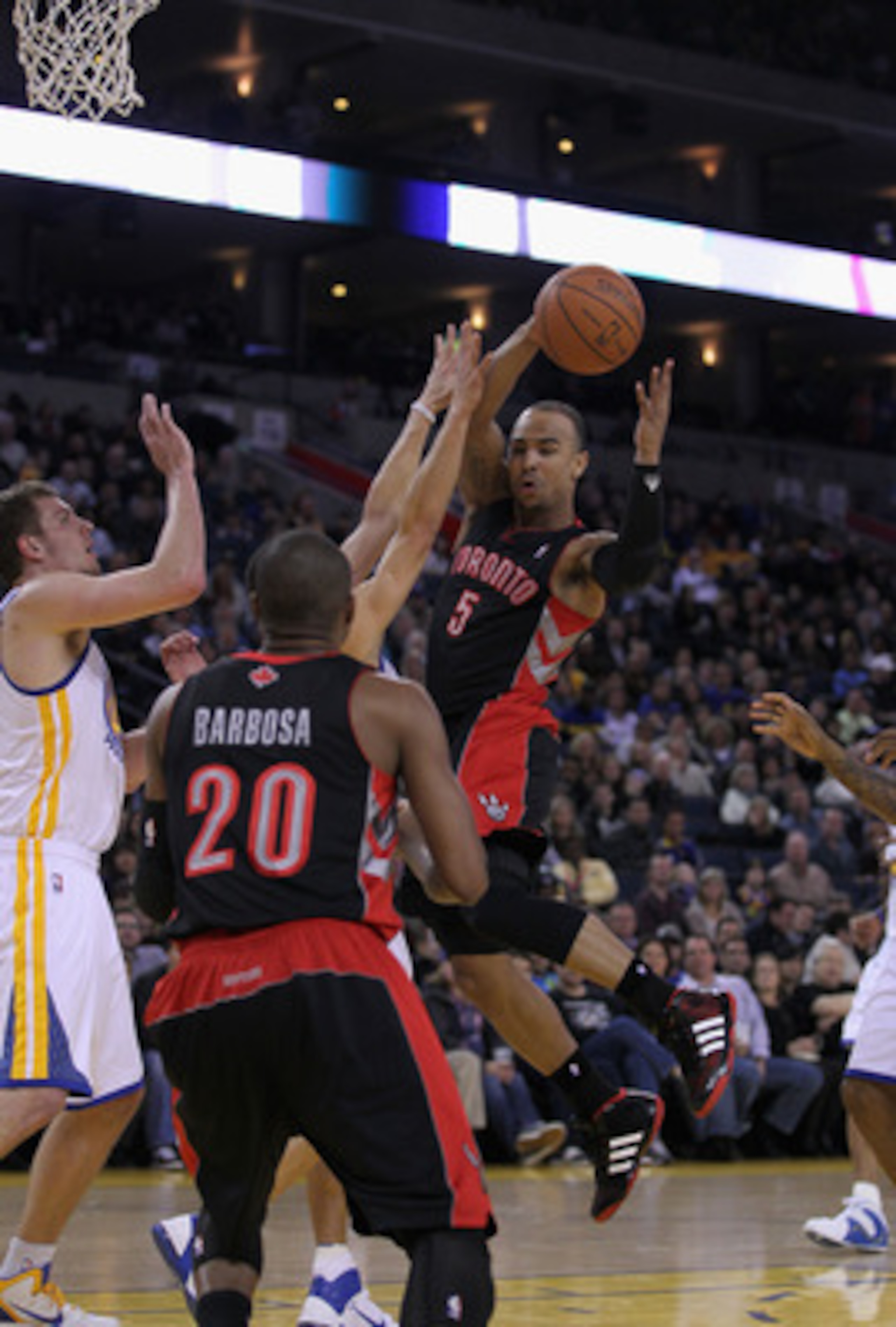 OAKLAND, CA - MARCH 25: Jerryd Bayless #5 of the Toronto Raptors passes the ball during their game against the Golden State Warriors at Oracle Arena on March 25, 2011 in Oakland, California. NOTE TO USER: User expressly acknowledges and agrees that, by do