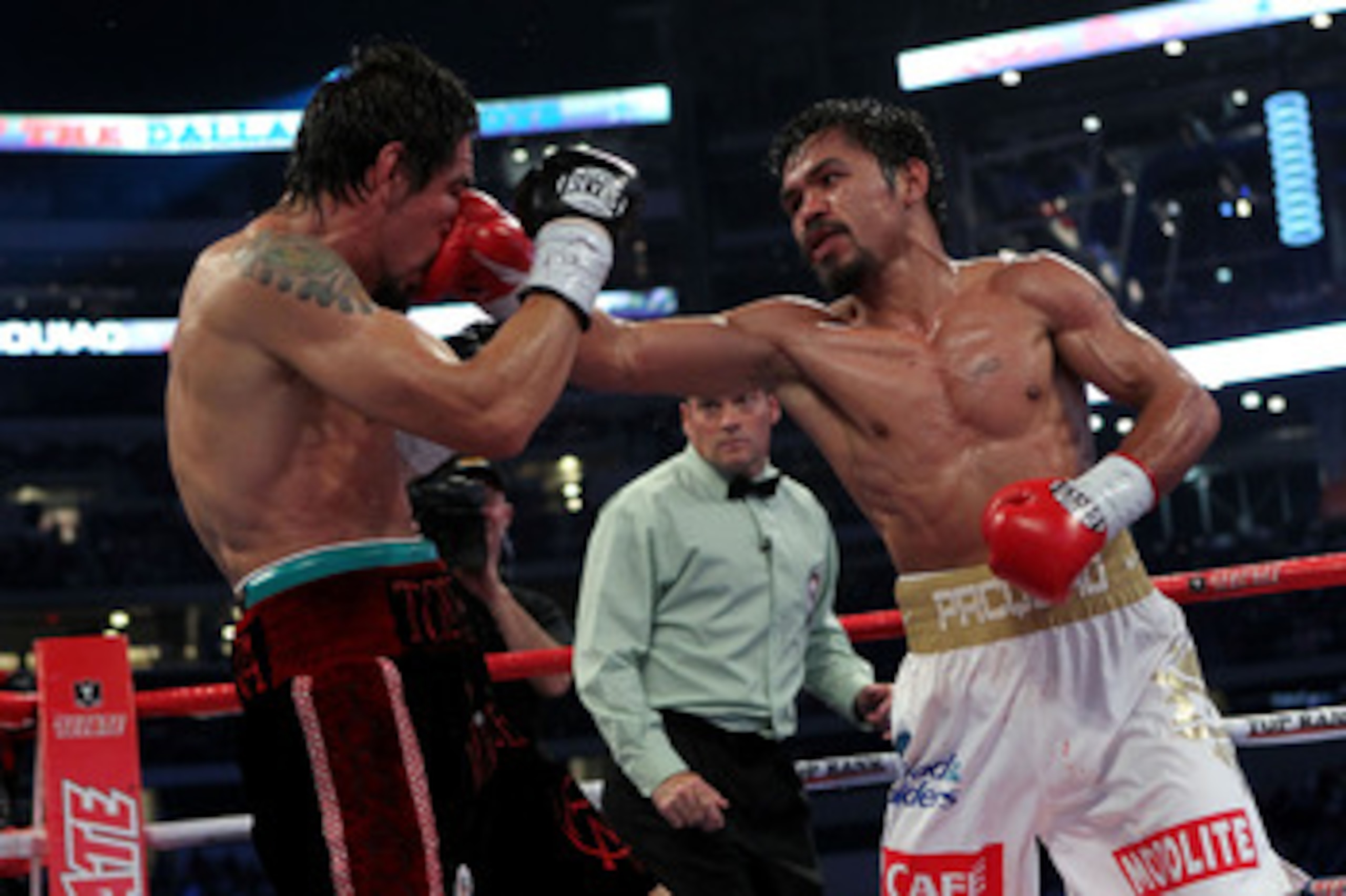 ARLINGTON, TX - NOVEMBER 13:  Manny Pacquiao (white trunks) of the Philippines lands a punch against Antonio Margarito (black trunks) of Mexico during their WBC World Super Welterweight Title bout at Cowboys Stadium on November 13, 2010 in Arlington, Texa