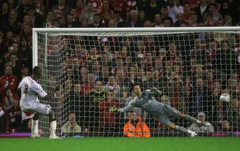LIVERPOOL, ENGLAND - SEPTEMBER 22:  Abdul Osman of Northampton Town scores the winning penalty in a shootout past Brad Jones of Liverpool during the Carling Cup Third Round game between Liverpool and Northampton Town at Anfield on September 22, 2010 in Li