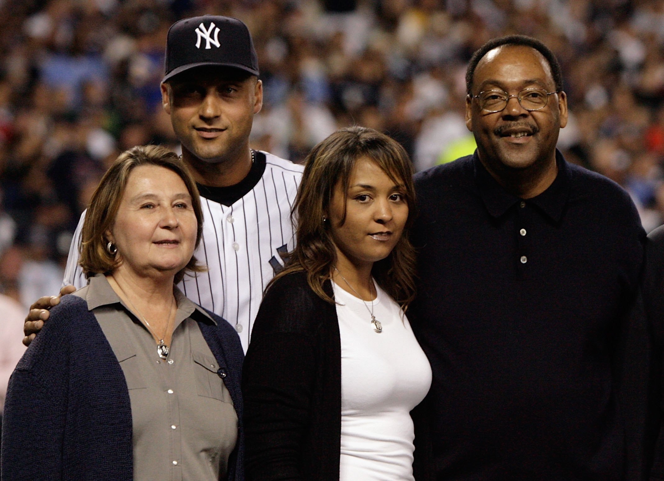 NEW YORK - SEPTEMBER 21: Derek Jeter #2 of the New York Yankees poses with his family, father Charles mother Dorothy and sister Sharlee,during pregame ceremonies prior to the start of the last regular season game at Yankee Stadium between the Baltimore Or