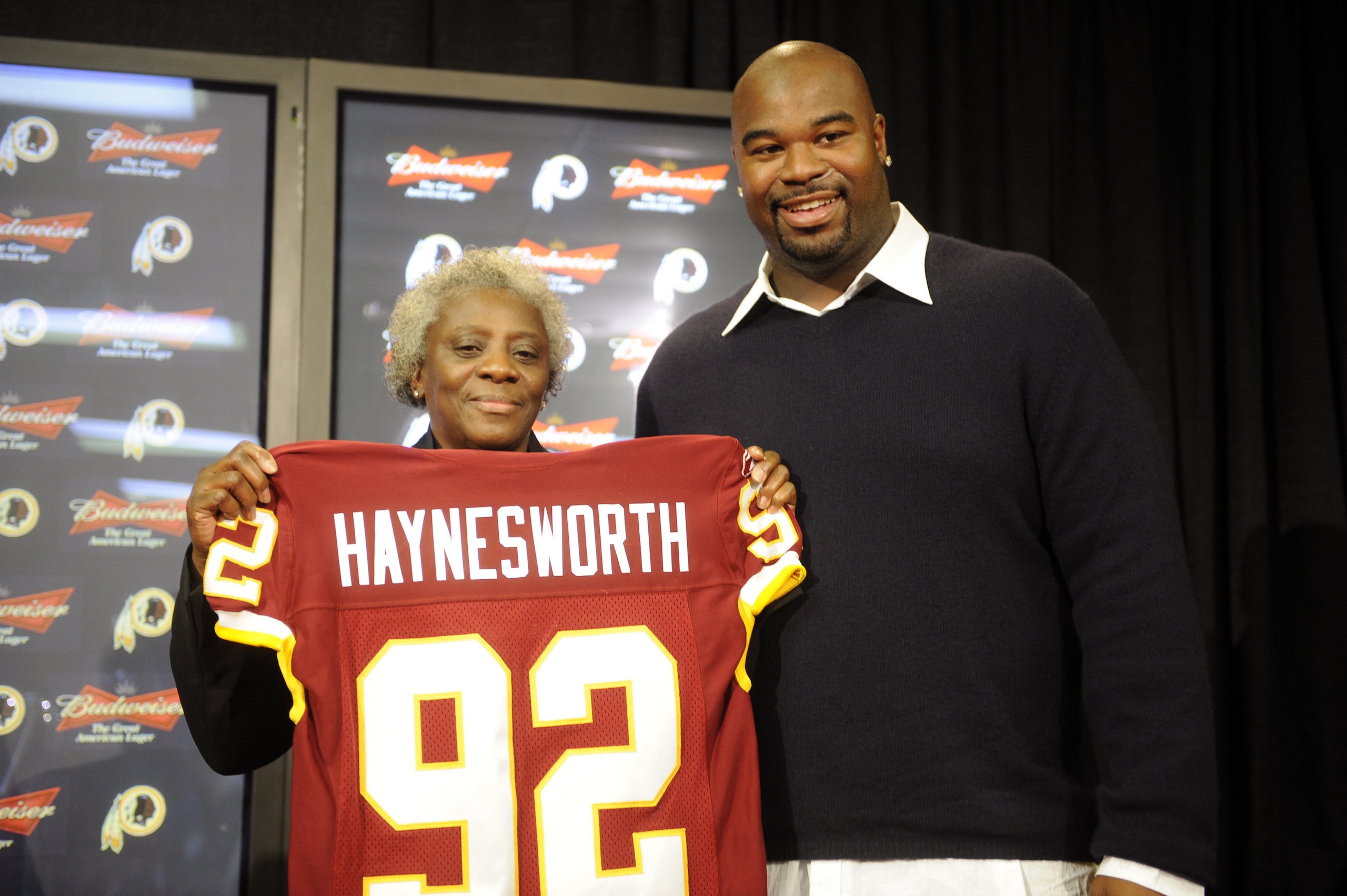 ASHBURN, VA - FEBRUARY 27:  Albert Haynesworth #92 and his mom Linda pose with his team jersey at a press conference after signing a 7-year contract worth approximately $100 million with the Washington Redskins on February 27, 2009 at Redskins Park in Ash