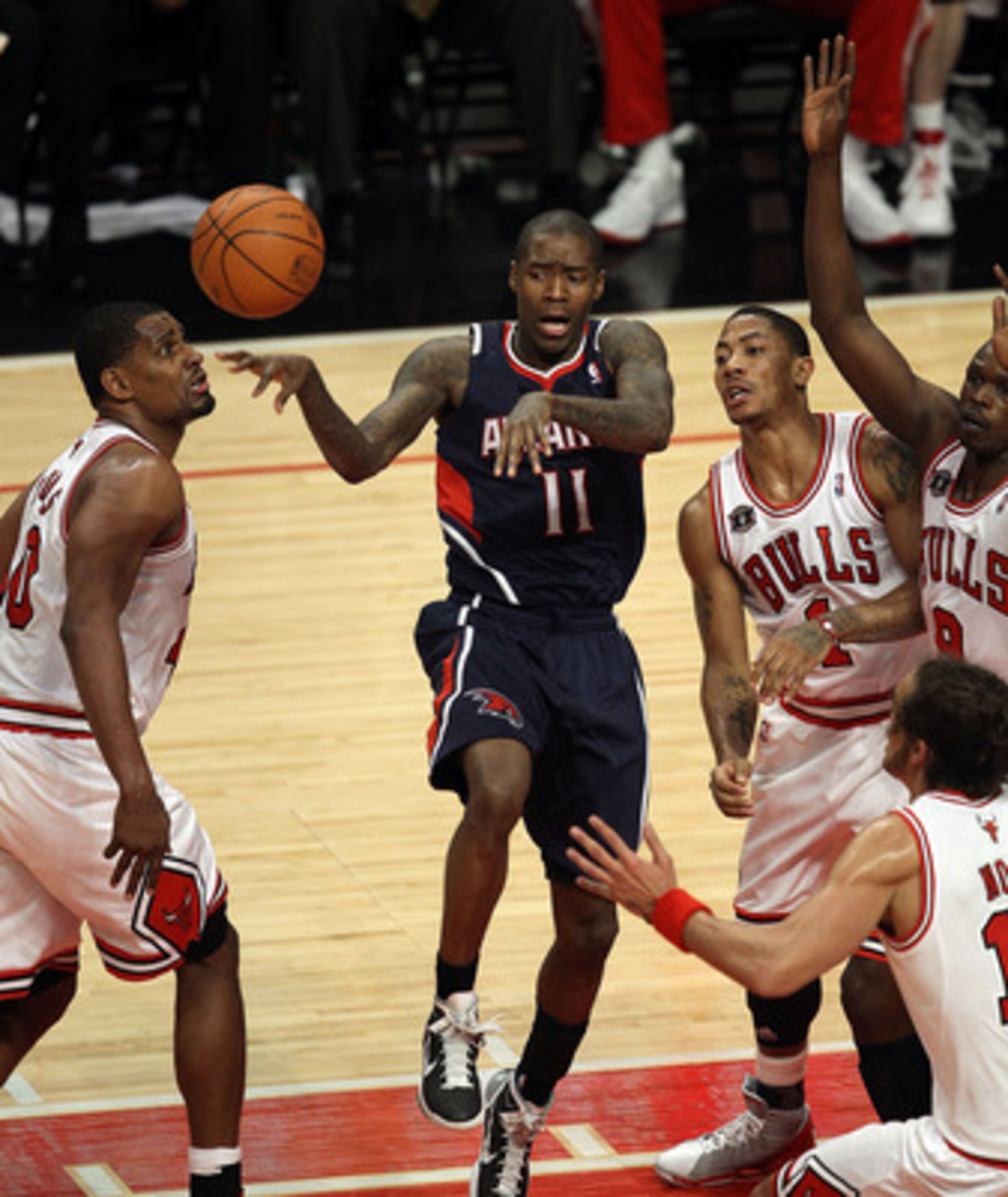 CHICAGO, IL - MARCH 11: Jamal Crawford #11 of the Atlanta Hawks passes the ball surrounded by (L-R)  Kurt Thomas #40, Derrick Rose #1, Loul Deng #9 and Joakim Noah #13 of the Chicago Bulls at the United Center on March 11, 2011 in Chicago, Illinois. The B