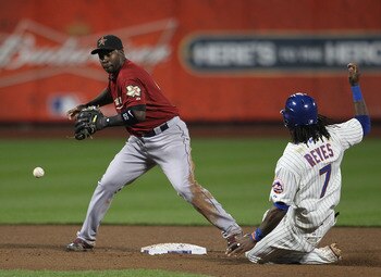 NEW YORK, NY - APRIL 19: Bill Hall #22  of the Houston Astros drops the ball trying to turn a double play in front of Jose Reyes #7 of the New York Mets at Citi Field on April 19, 2011 in the Flushing neighborhood of the Queens borough of New York City.  