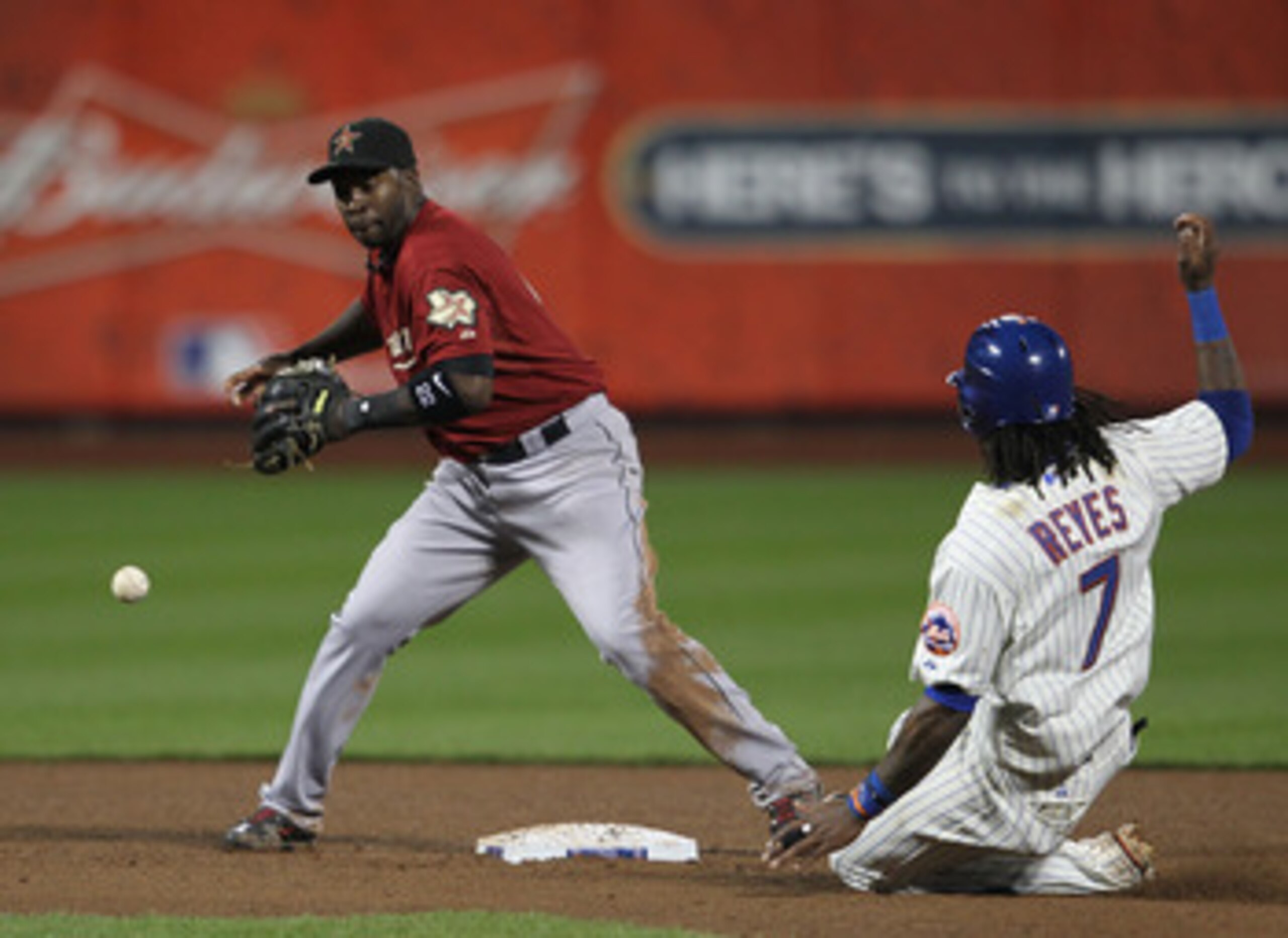 NEW YORK, NY - APRIL 19: Bill Hall #22  of the Houston Astros drops the ball trying to turn a double play in front of Jose Reyes #7 of the New York Mets at Citi Field on April 19, 2011 in the Flushing neighborhood of the Queens borough of New York City.  