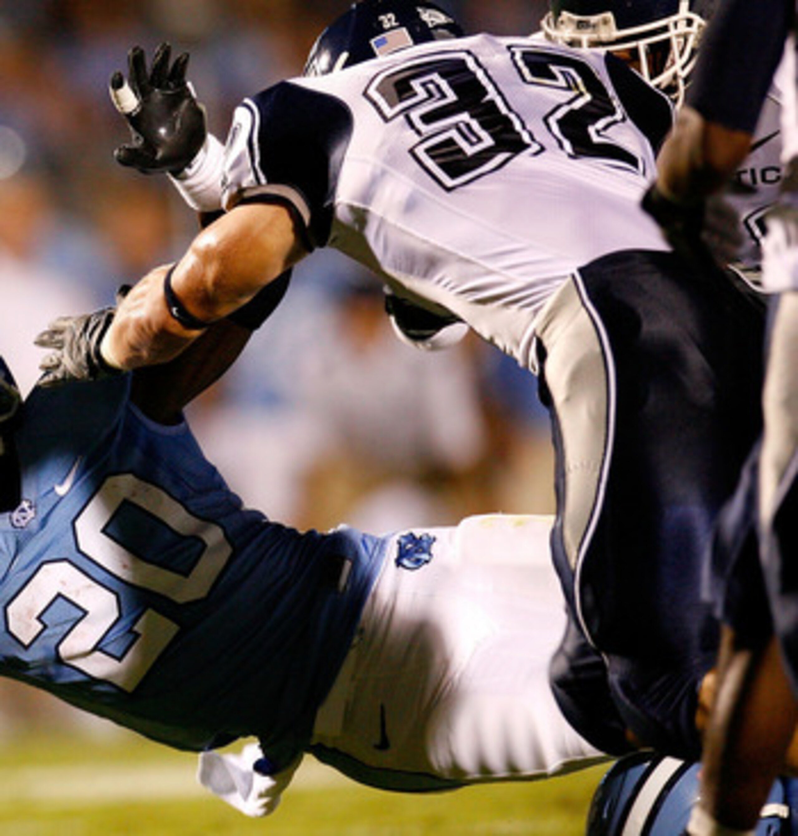 CHAPEL HILL, NC - OCTOBER 04: Running back Shaun Draughn #20 of the North Carolina Tar Heels dives for more yardage against Scott Lutrus #32 of the Connecticut Huskies during the game at Kenan Stadium on October 4, 2008 in Chapel Hill, North Carolina. ( CHAPEL HILL, NC - OCTOBER 04: Running back Shaun Draughn #20 of the North Carolina Tar Heels dives for more yardage against Scott Lutrus #32 of the Connecticut Huskies during the game at Kenan Stadium on October 4, 2008 in Chapel Hill, North Carolina. (