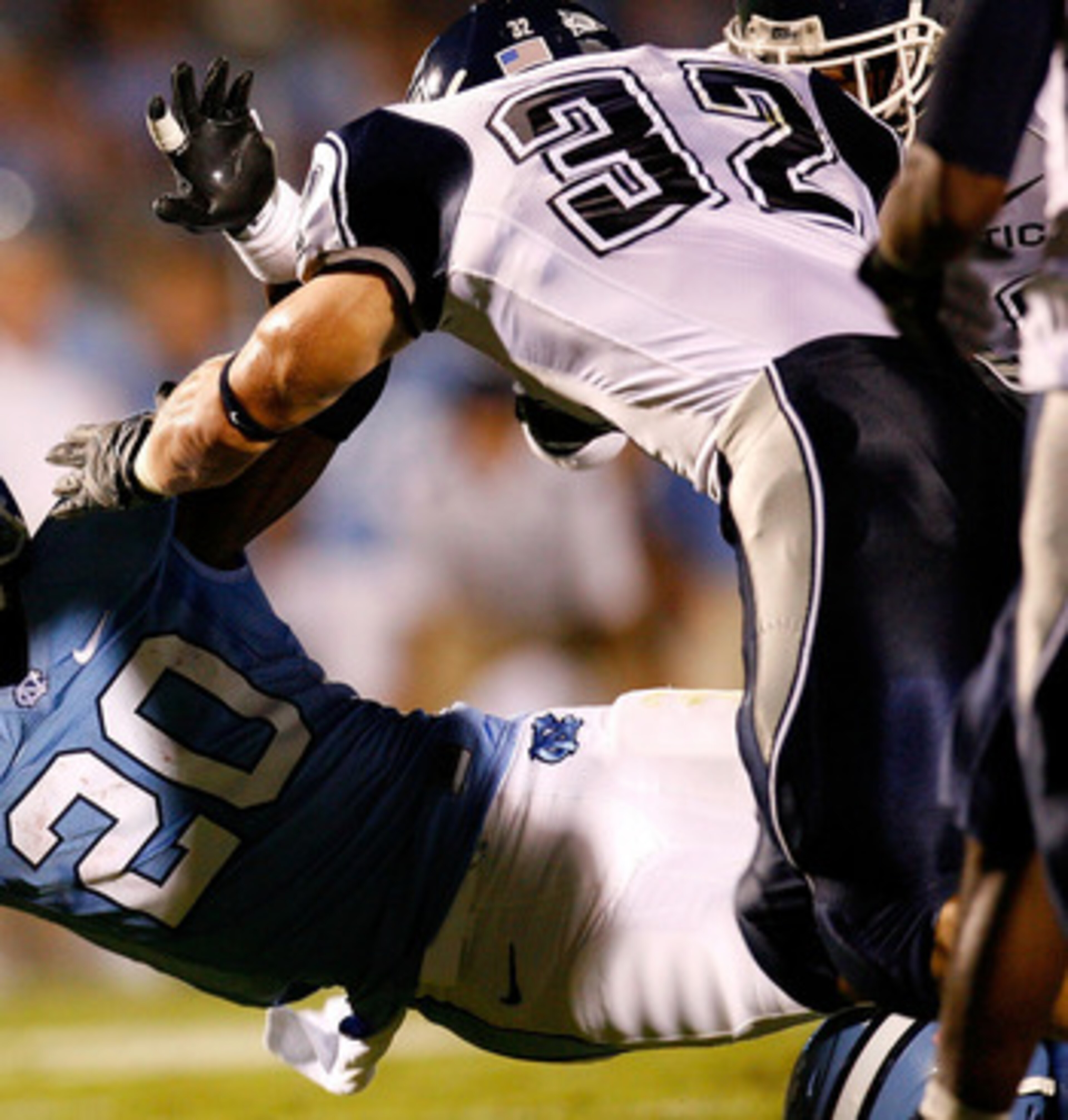 CHAPEL HILL, NC - OCTOBER 04:  Running back Shaun Draughn #20 of the North Carolina Tar Heels dives for more yardage against Scott Lutrus #32 of the Connecticut Huskies during the game at Kenan Stadium on October 4, 2008 in Chapel Hill, North Carolina.  (