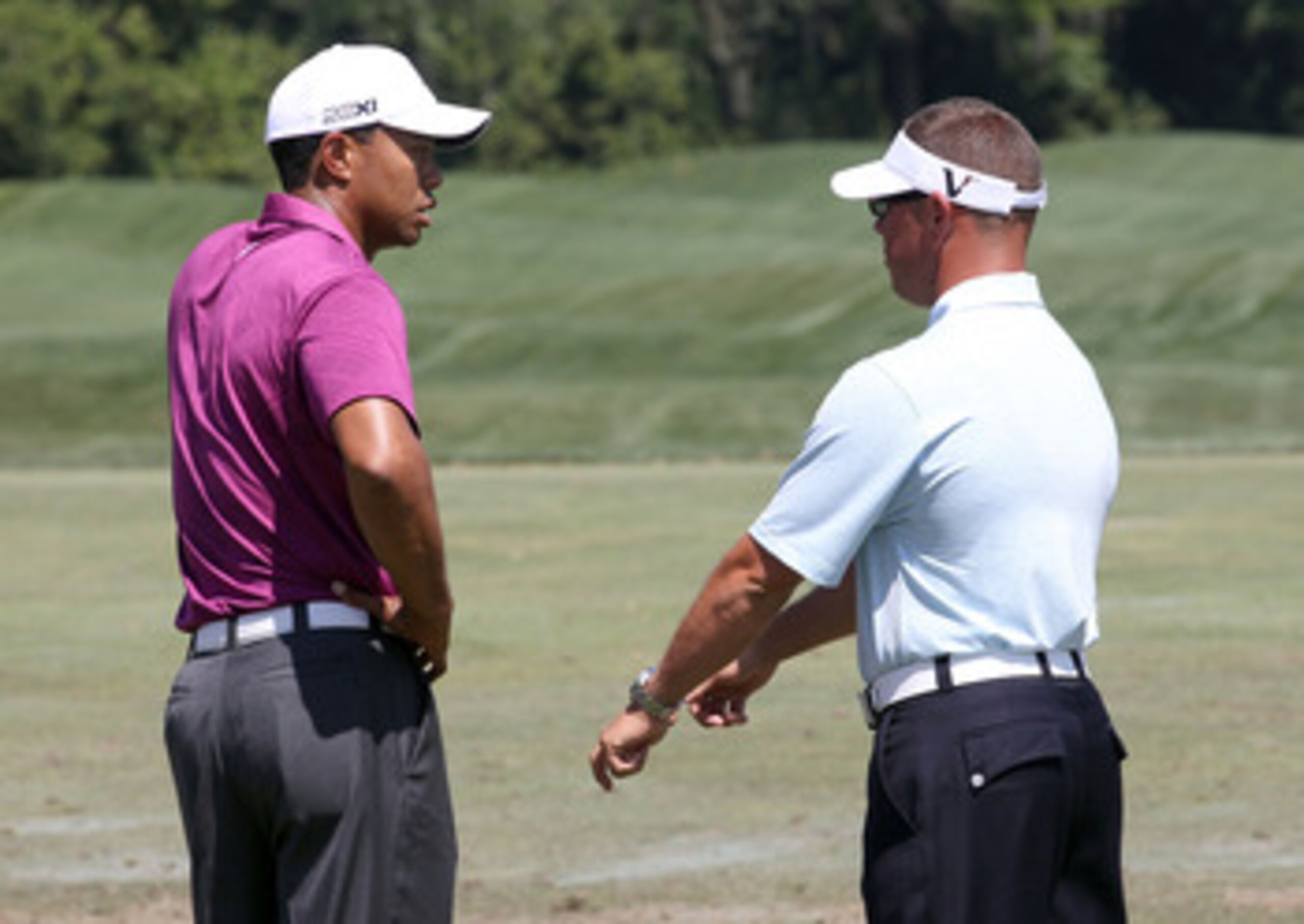 ORLANDO, FL - MARCH 26:  Tiger Woods (L) speaks with swing coach Sean Foley prior to the third round of the Arnold Palmer Invitational presented by MasterCard at the Bay Hill Club and Lodge on March 26, 2011 in Orlando, Florida.  (Photo by Sam Greenwood/G