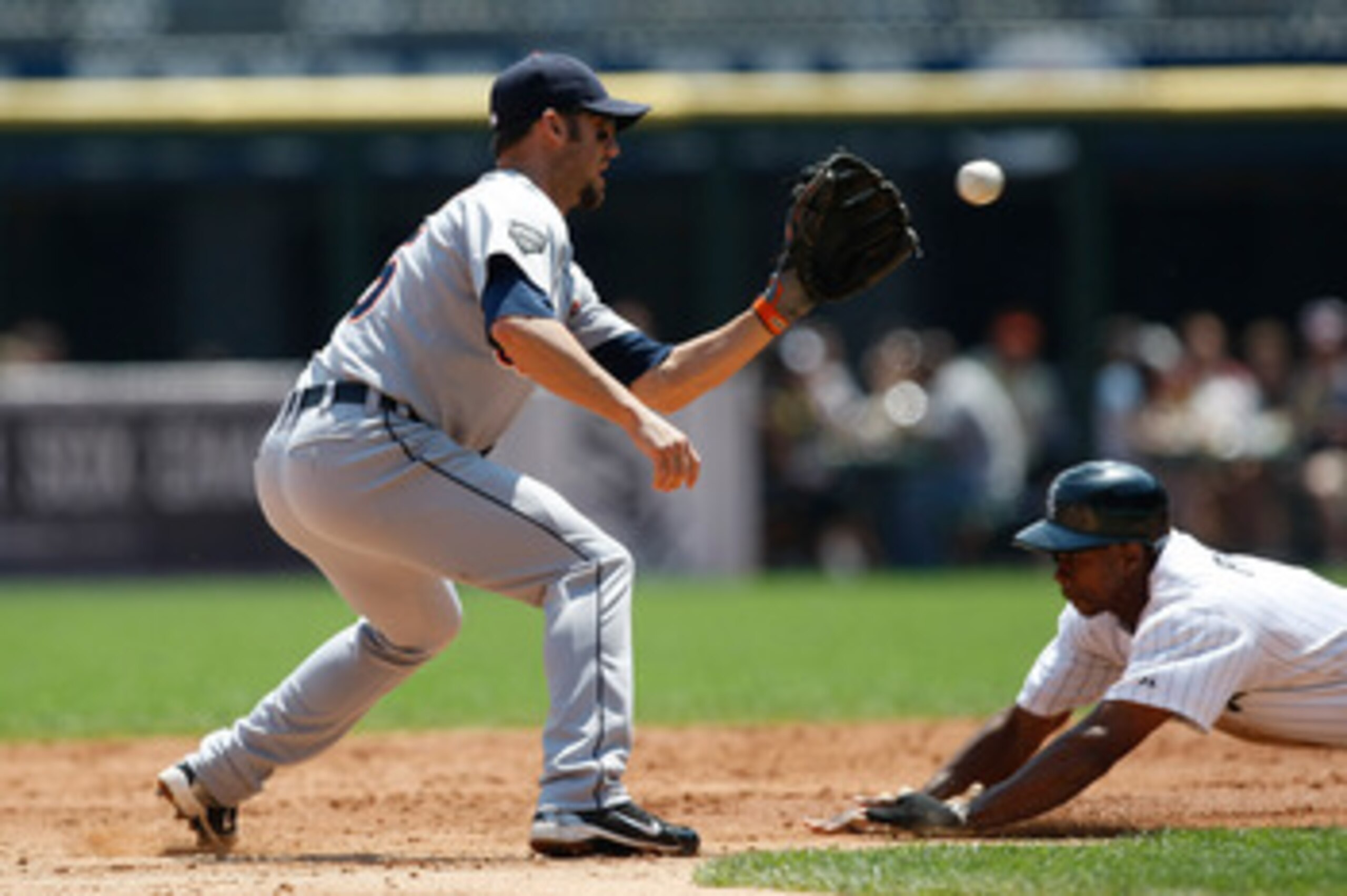 CHICAGO, IL- JUNE 5: Ryan Raburn #25 of the Detroit Tigers catches the baseball as Juan Pierre #1 of the Chicago White Sox slides into second base at U.S. Cellular Field on June 5, 2011 in Chicago, Illinois. (Photo by Scott Boehm/Getty Images)
