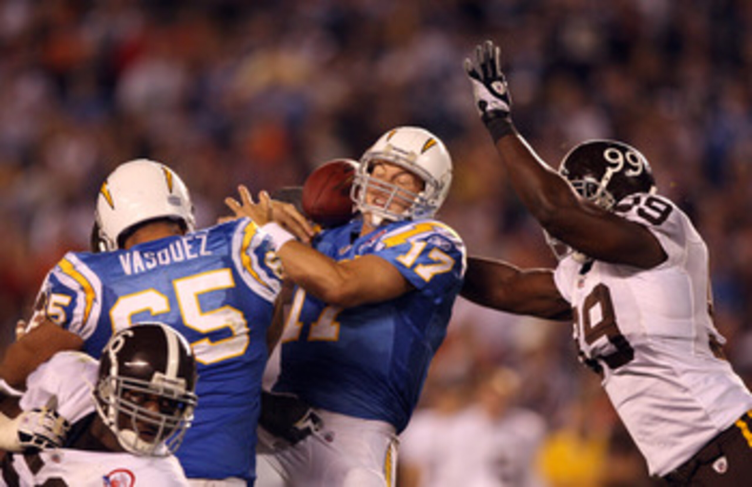 SAN DIEGO, CA - OCTOBER 19: Quarterback Phillip Rivers #17 of the San Diego Chargers losses the ball for a sack as he is pressured by Defensive Linebacker Vonnie Holliday #99 of the Denver Broncos during the second half during Monday Night Football on Oct