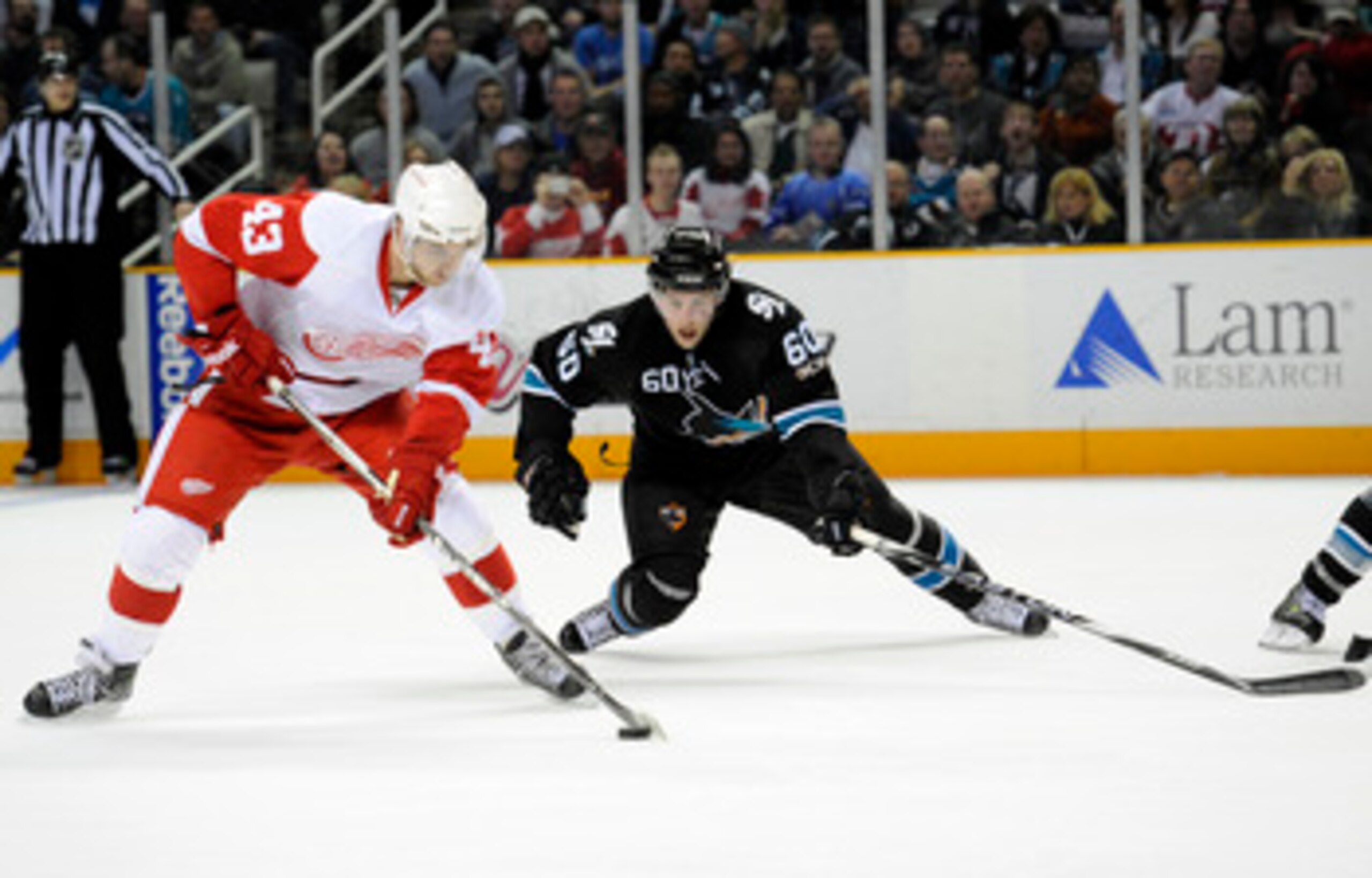 SAN JOSE, CA - MARCH 3: Jason Demers #60 of the San Jose Sharks defends Darren Helm #43 of the Detroit Red Wings in the third period of an NHL hockey game at the HP Pavilion on March 3, 2011 in San Jose, California. The Sharks won the game 3-1. (Photo by