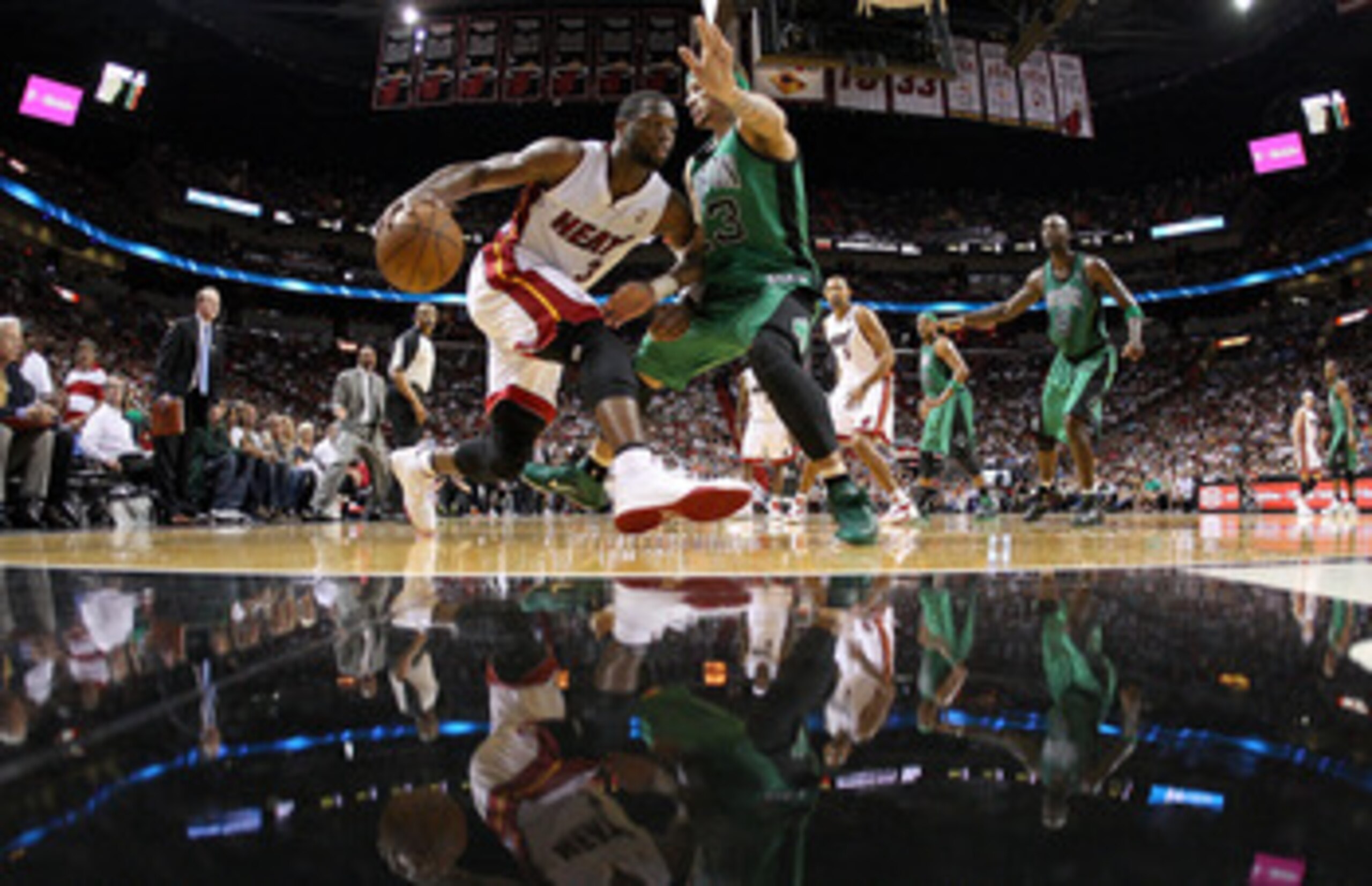 MIAMI, FL - APRIL 10:  Dwyane Wade #3 of the Miami Heat drives on Delonte West #13 of the Boston Celtics during a game  at American Airlines Arena on April 10, 2011 in Miami, Florida. NOTE TO USER: User expressly acknowledges and agrees that, by downloadi