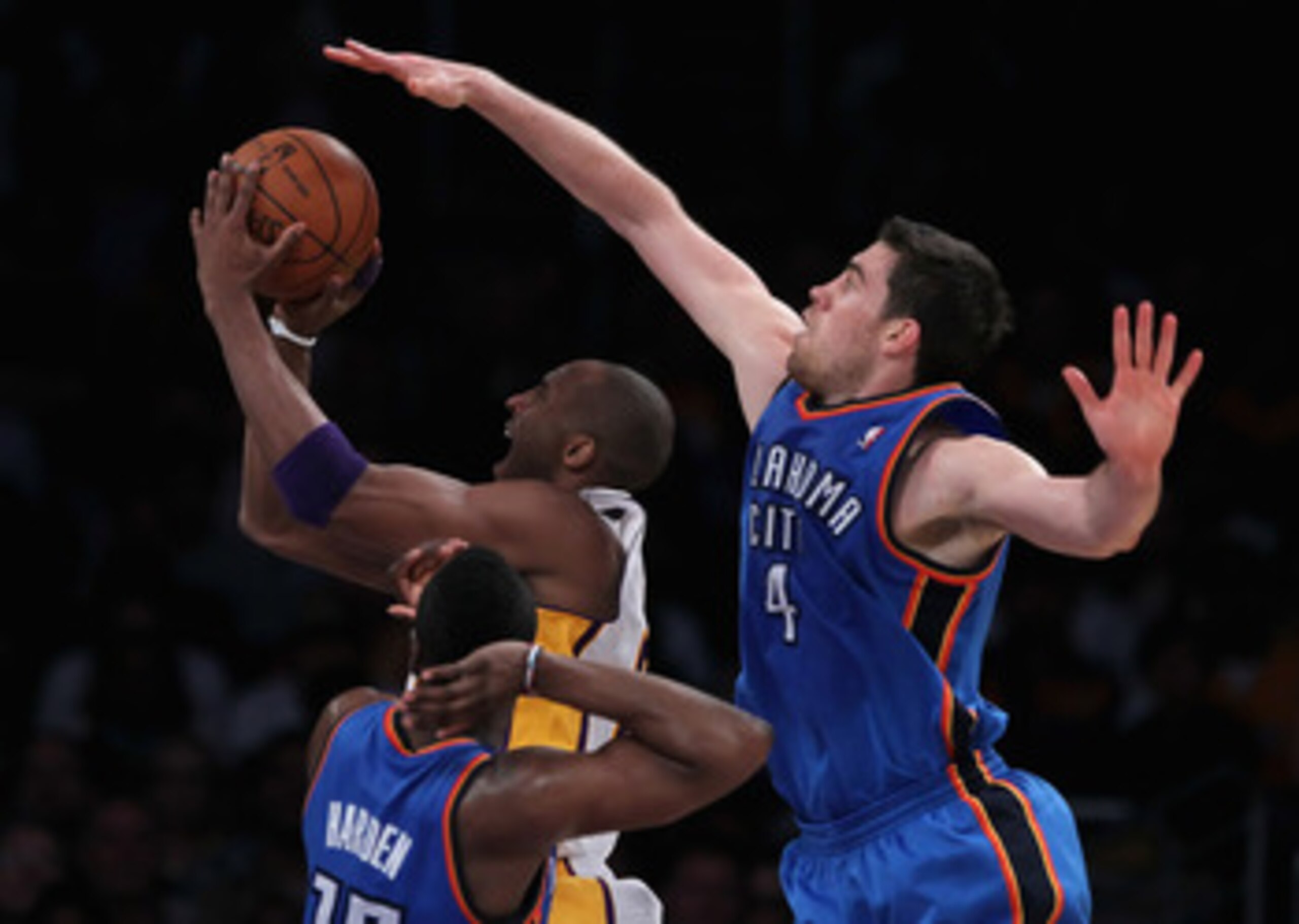 LOS ANGELES, CA - APRIL 10:  Kobe Bryant #24 of the Los Angeles Lakers is defended by Nick Collison #4 of the Oklahoma City Thunder in the second half at Staples Center on April 10, 2011 in Los Angeles, California. The Thunder defeated the Lakers 120-106.