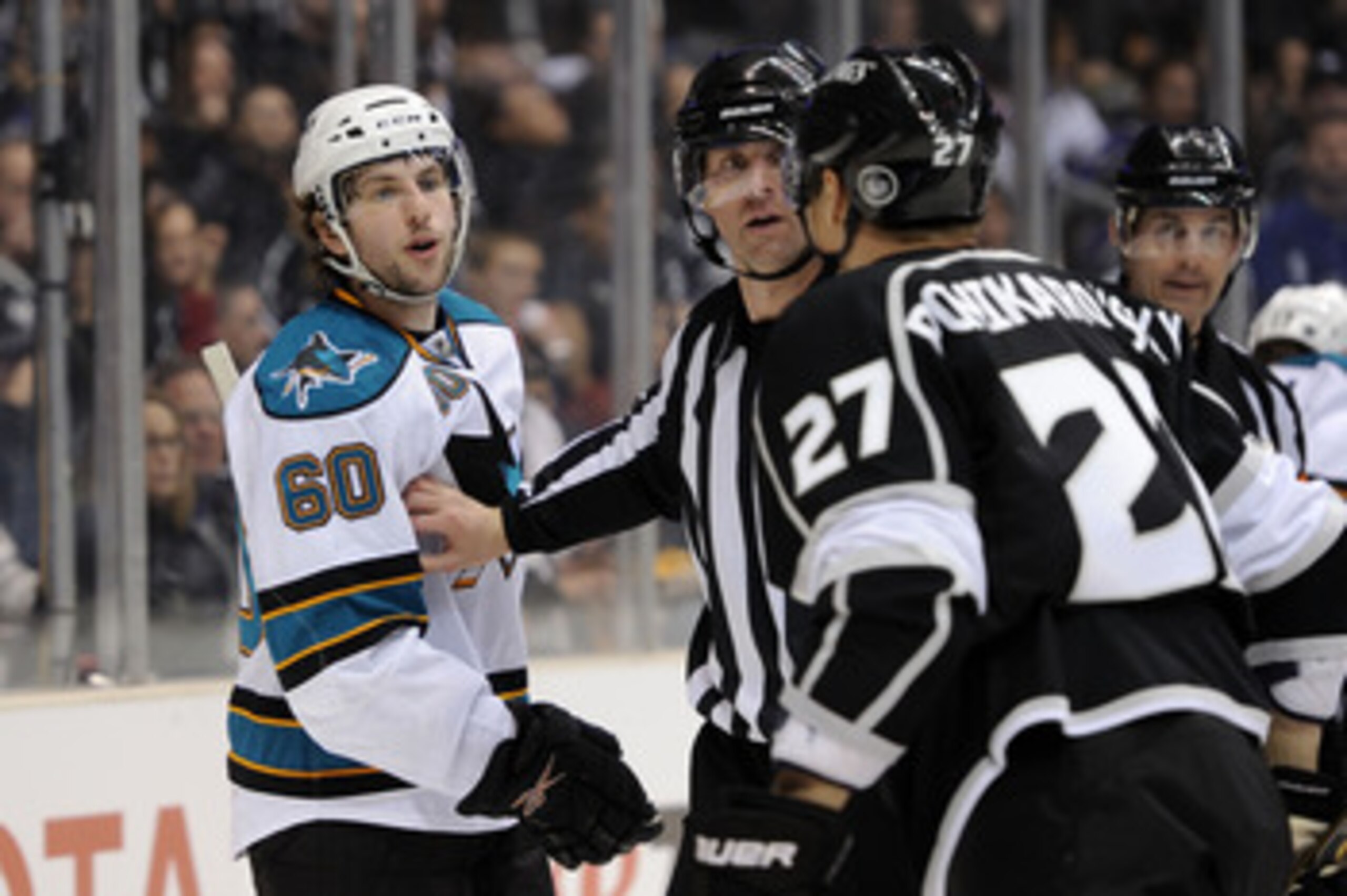 LOS ANGELES, CA - APRIL 19:  Jason Demers #60 of the San Jose Sharks and Alexei Ponikarovsky #27 of the Los Angeles Kings exchange words with each other after being separated by the referee in game three of the Western Conference Quarterfinals during the 