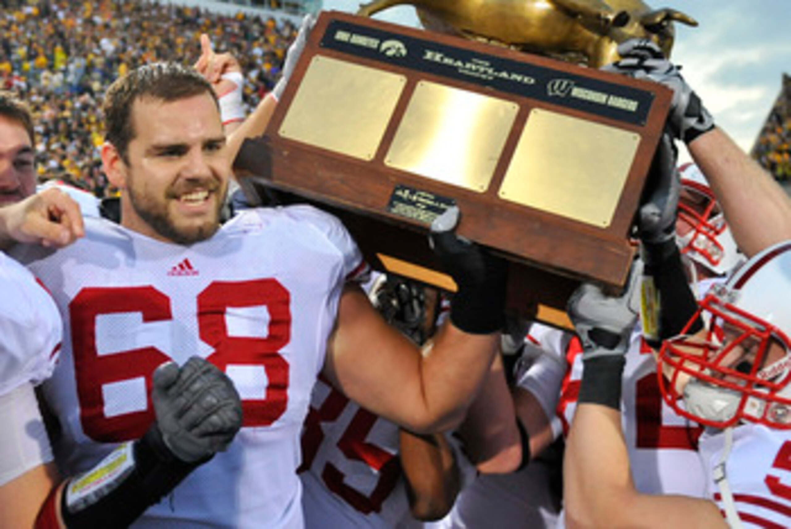 IOWA CITY, IA - OCTOBER 23: Offensive lineman Gabe Carimi #68 for the Wisconsin Badger holds the Heartland Trophy with his teammates as they celebrate their victory of the University of Iowa Hawkeyes at Kinnick Stadium on October 23, 2010 in Iowa City, Io