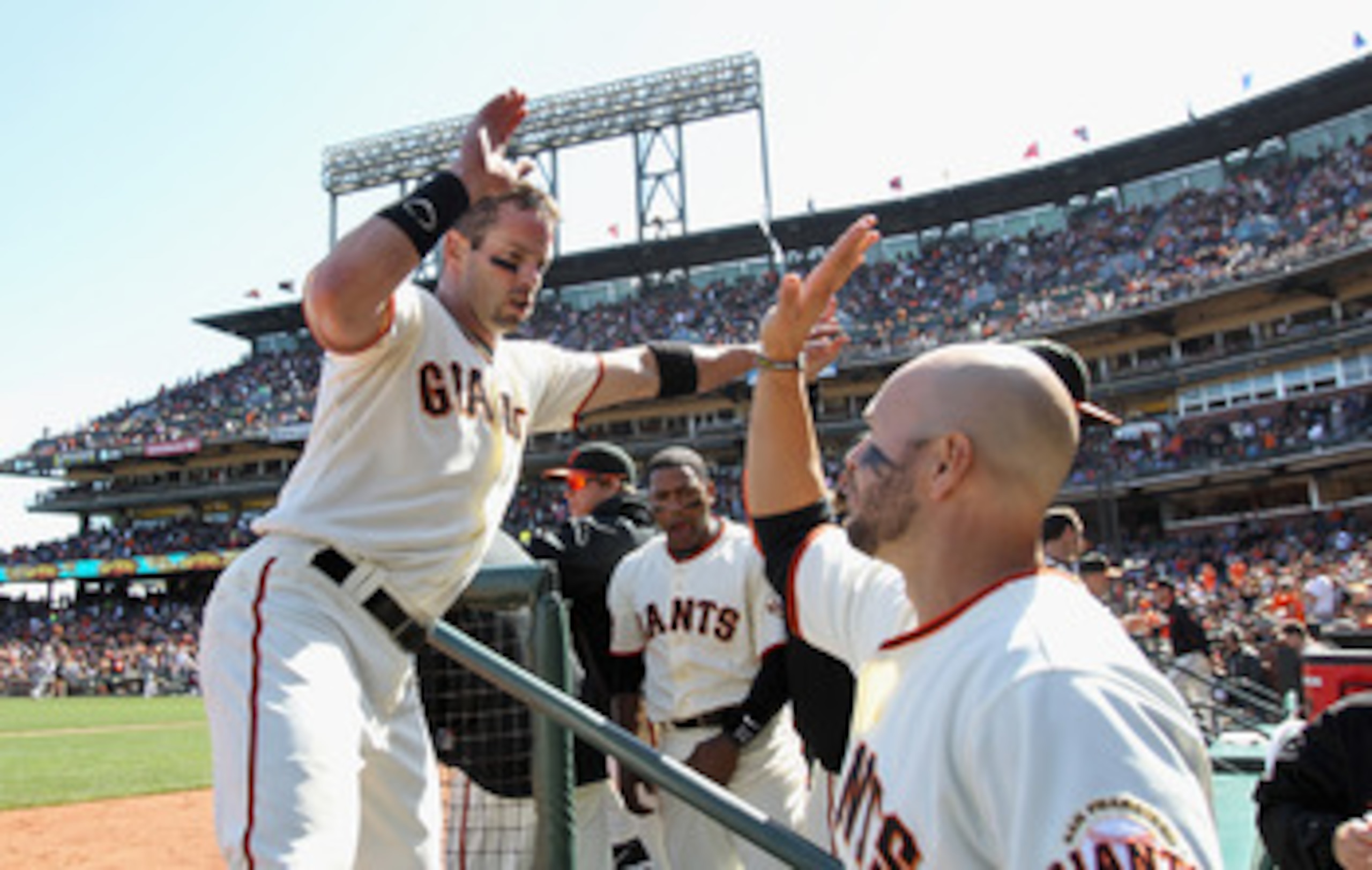 SAN FRANCISCO, CA - APRIL 24:  Aaron Rowand #33 is congratulated by Cody Ross #13 of the San Francisco Giants after he hit a two run double to give them a 6-5 lead over the Atlanta Braves in the seventh inning at AT&T Park on April 24, 2011 in San Francis