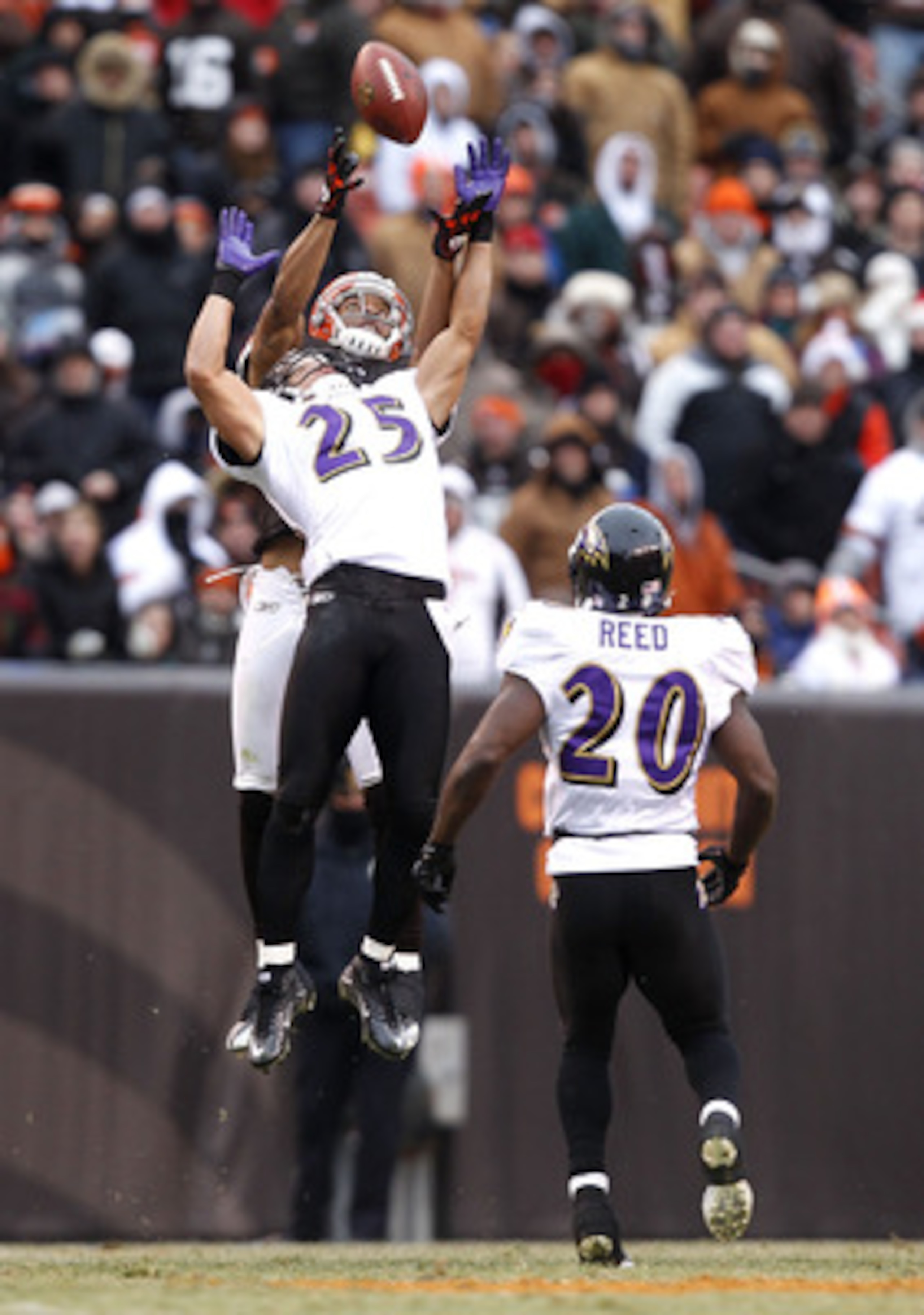CLEVELAND - DECEMBER 26: Safety Chris Carr #25 of the Baltimore Ravens jumps for the ball as safety Ed Reed #20 looks on with wide receiver Chansi Stuckey #83 of the Cleveland Browns at Cleveland Browns Stadium on December 26, 2010 in Cleveland, Ohio. ( CLEVELAND - DECEMBER 26: Safety Chris Carr #25 of the Baltimore Ravens jumps for the ball as safety Ed Reed #20 looks on with wide receiver Chansi Stuckey #83 of the Cleveland Browns at Cleveland Browns Stadium on December 26, 2010 in Cleveland, Ohio. (