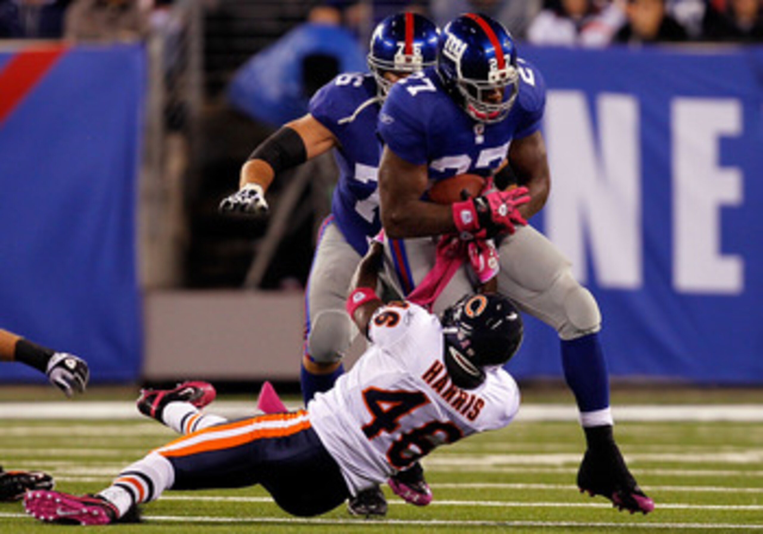EAST RUTHERFORD, NJ - OCTOBER 03:  Chris Harris #46 of the Chicago Bears tries to tackle Brandon Jacobs #27 of the New York Giants at New Meadowlands Stadium on October 3, 2010 in East Rutherford, New Jersey.  (Photo by Michael Heiman/Getty Images)