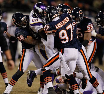 CHICAGO - DECEMBER 28: Adrian Peterson #28 of the Minnesota Vikings is gang-tackled by members of the Chicago Bears including Danieal Manning #38 and Mark Anderson #97 at Soldier Field on December 28, 2009 in Chicago, Illinois. The Bears defeated the Viki