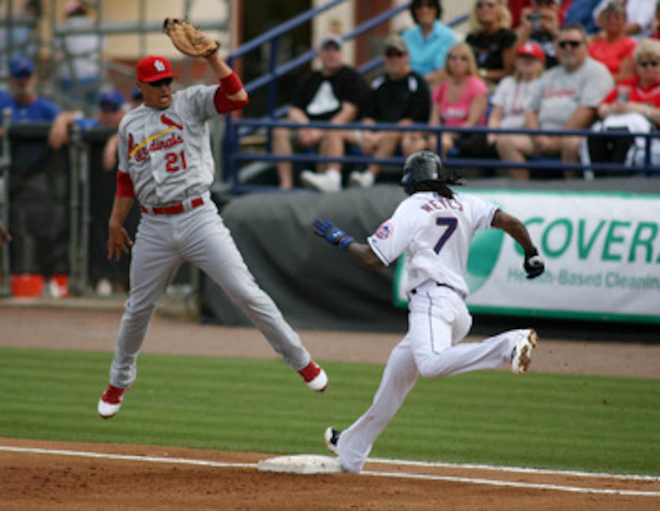 PORT ST. LUCIE, FL - MARCH 03: First baseman Allen Craig #21 of the St. Louis Cardinals cannot make a play on Jose Reyes #7 of the New York Mets at Digital Domain Park on March 3, 2011 in Port St. Lucie, Florida.  (Photo by Marc Serota/Getty Images)