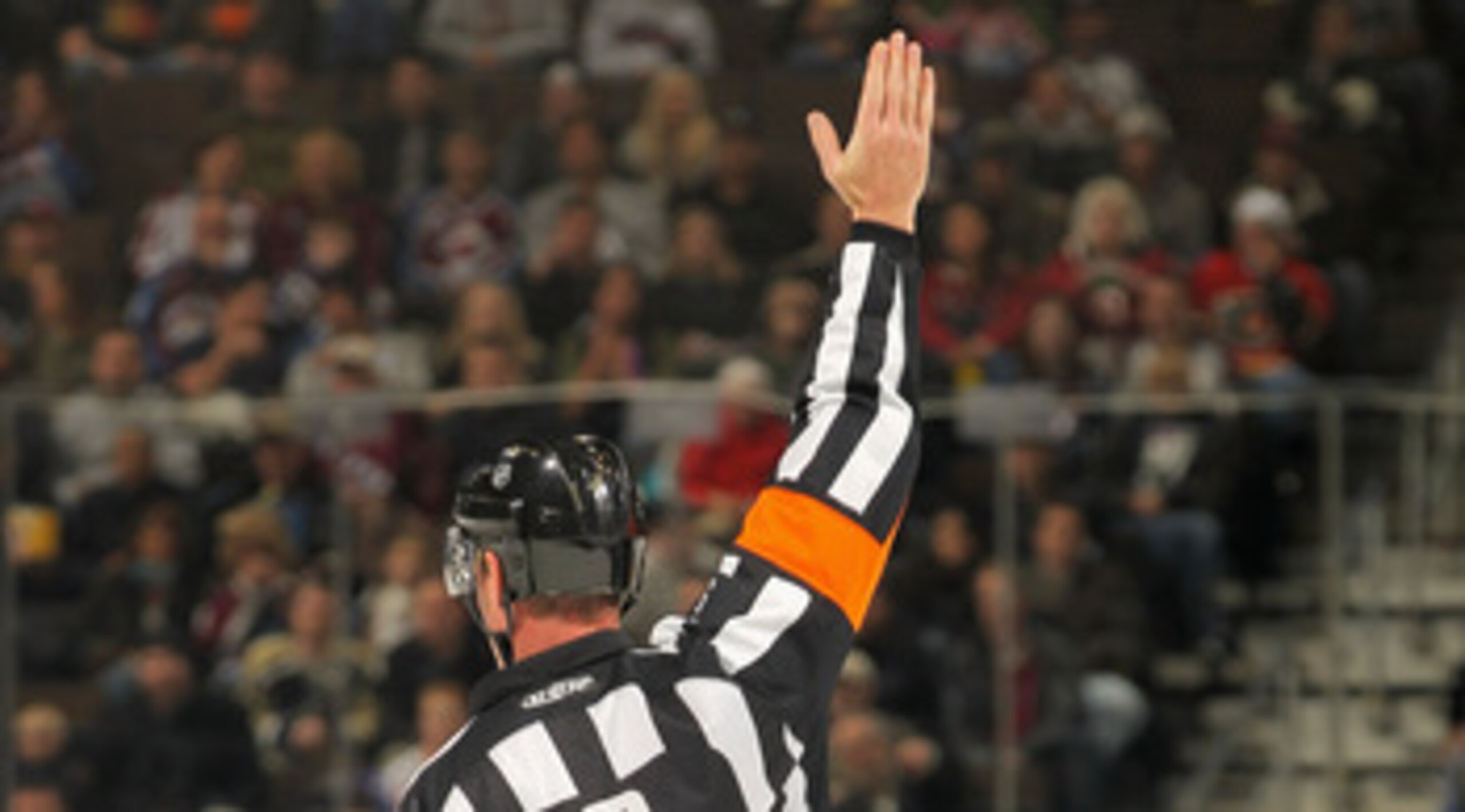 DENVER - NOVEMBER 09:  Referee Dan O'Rourke #9 signals a penalty between the Calgary Flames and the Colorado Avalanche at the Pepsi Center on November 9, 2010 in Denver, Colorado. The Flames defeated the Avalanche 4-2.  (Photo by Doug Pensinger/Getty Imag