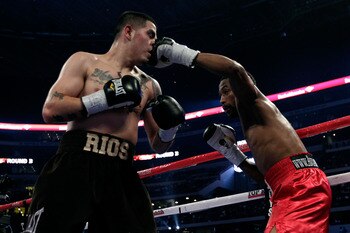ARLINGTON, TX - NOVEMBER 13:  Omri Lowther (R in red trunks) lands a punch to the face against Brandon Rios (brown trunks) during their Super Lightweight bout at Cowboys Stadium on November 13, 2010 in Arlington, Texas.  (Photo by Nick Laham/Getty Images)