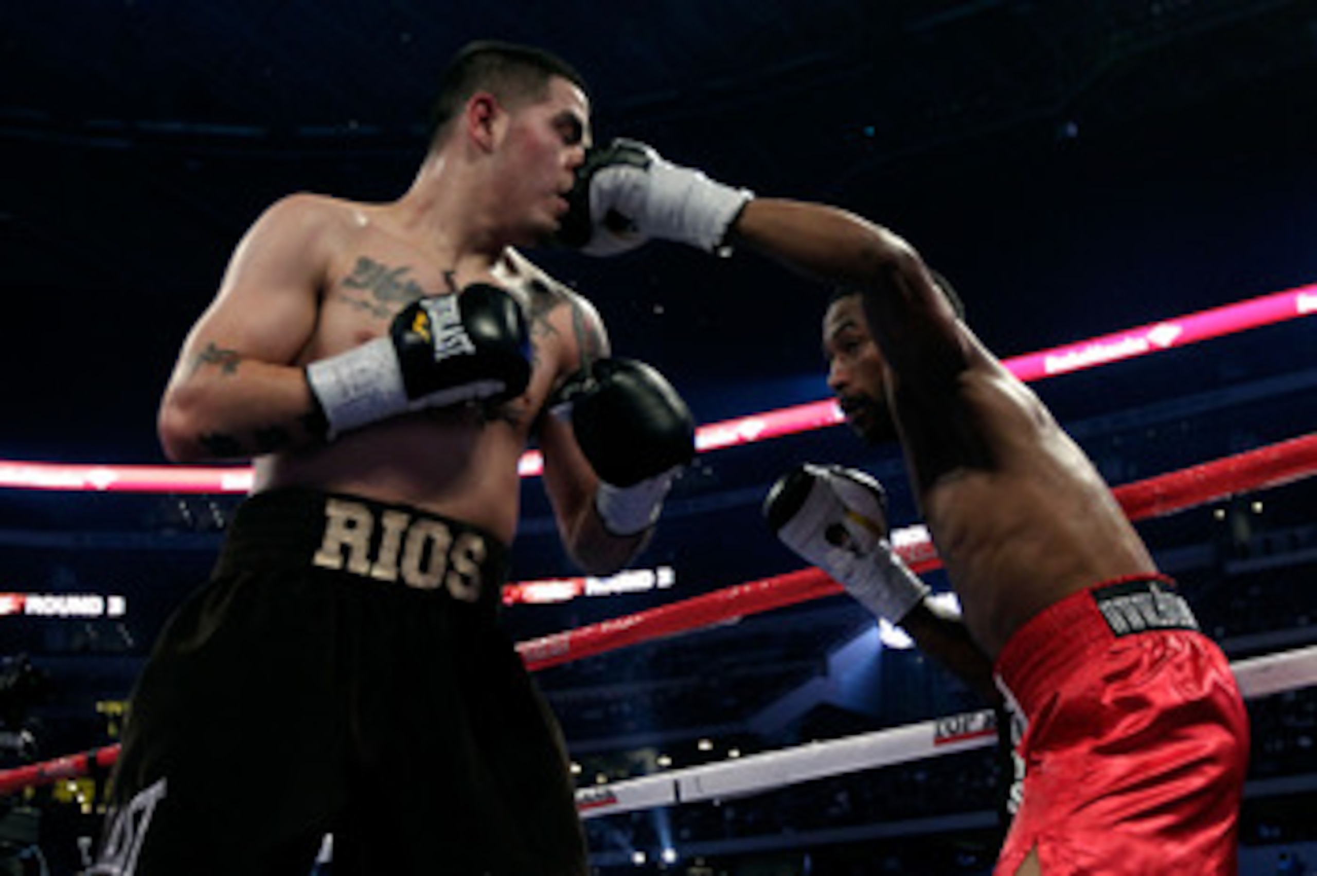 ARLINGTON, TX - NOVEMBER 13:  Omri Lowther (R in red trunks) lands a punch to the face against Brandon Rios (brown trunks) during their Super Lightweight bout at Cowboys Stadium on November 13, 2010 in Arlington, Texas.  (Photo by Nick Laham/Getty Images)