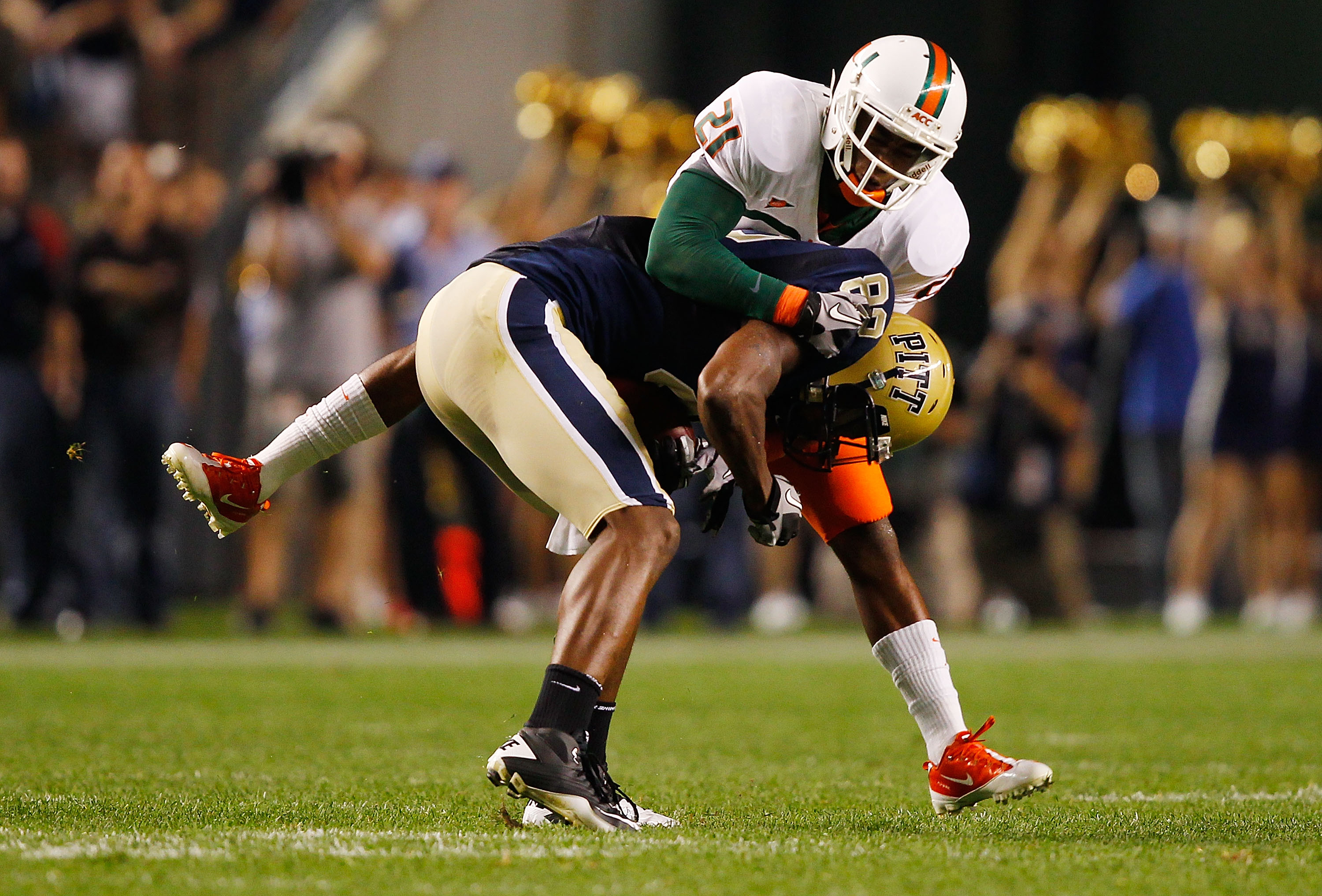 PITTSBURGH - SEPTEMBER 23:  Jon Baldwin #82 of the Pittsburgh Panthers is tackled by Brandon McGee #21 of the Miami Hurricanes on September 23, 2010 at Heinz Field in Pittsburgh, Pennsylvania.  (Photo by Jared Wickerham/Getty Images)