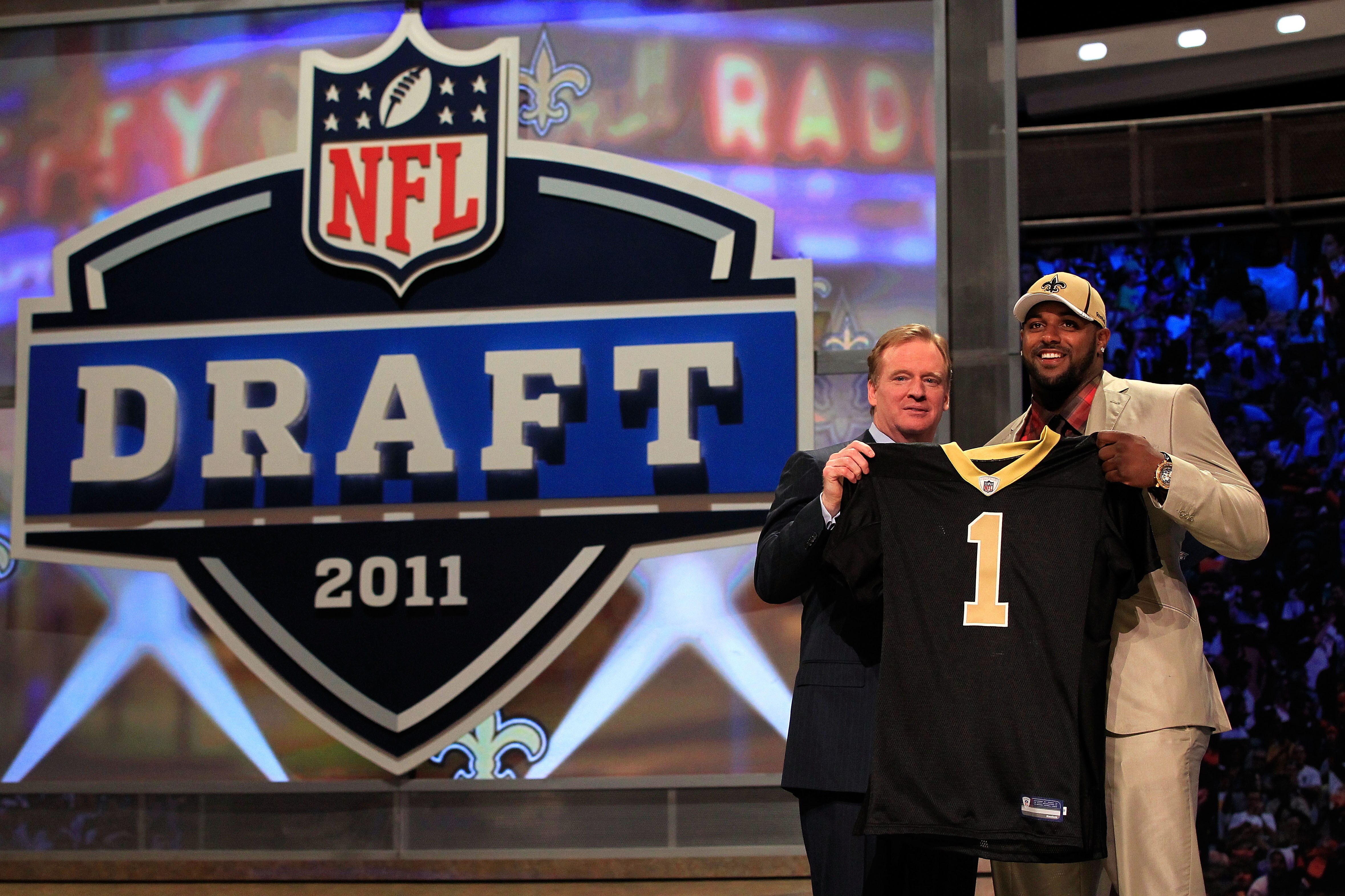 NEW YORK, NY - APRIL 28:  NFL Commissioner Roger Goodell (L) poses for a photo with Cameron Jordan, #24 overall pick by the New Orleans Saints, holds up a jersey on stage during the 2011 NFL Draft at Radio City Music Hall on April 28, 2011 in New York Cit