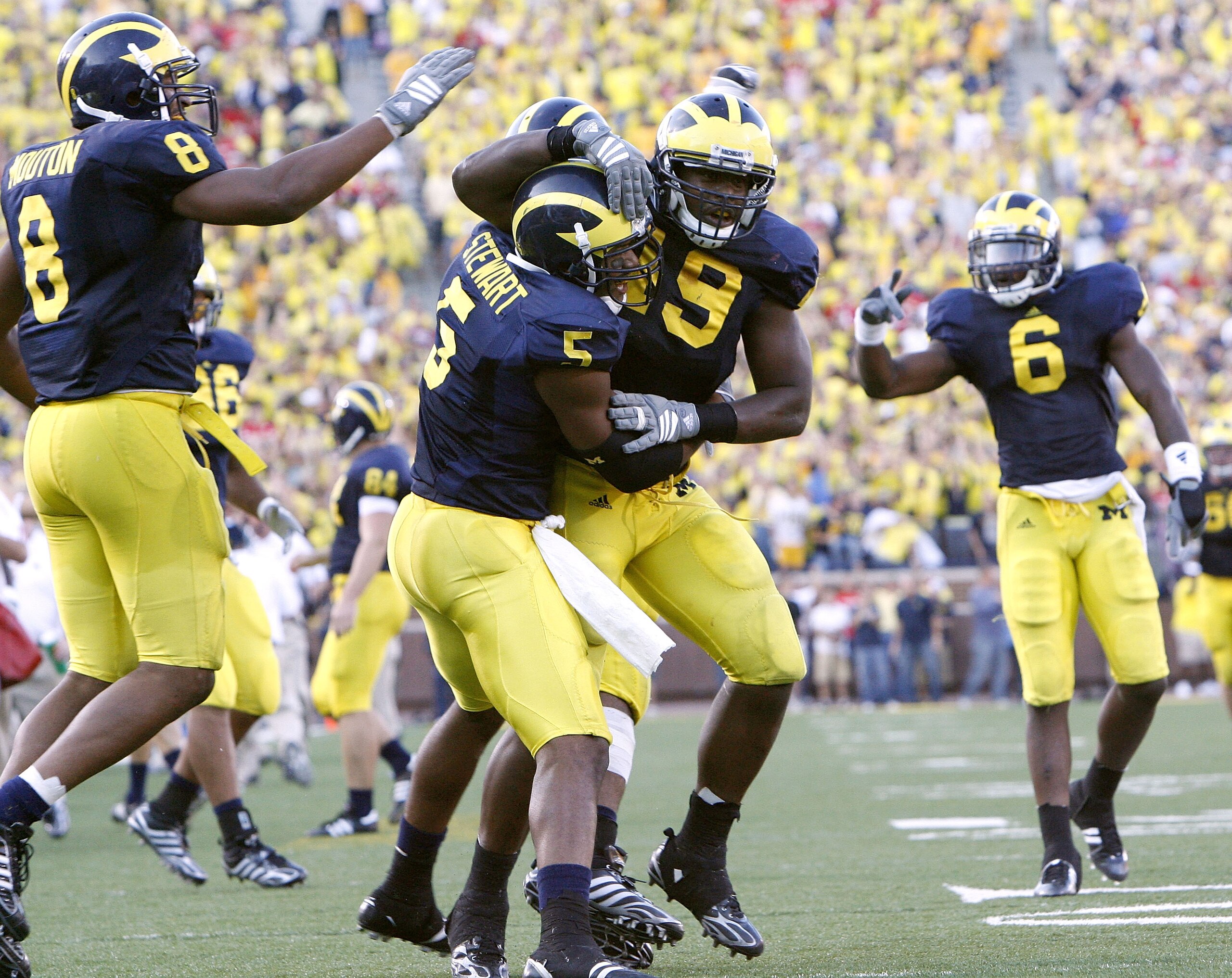 ANN ARBOR, MI - SEPTEMBER 27:  John Thompson #49, Charles Stewart #5, Donovan Warren #6 and Jonas Mouton #8 of the Michigan Wolverines celebrate an interception during the fourth quarter against the Wisconsin Badgers on September 27, 2008 at Michigan Stad
