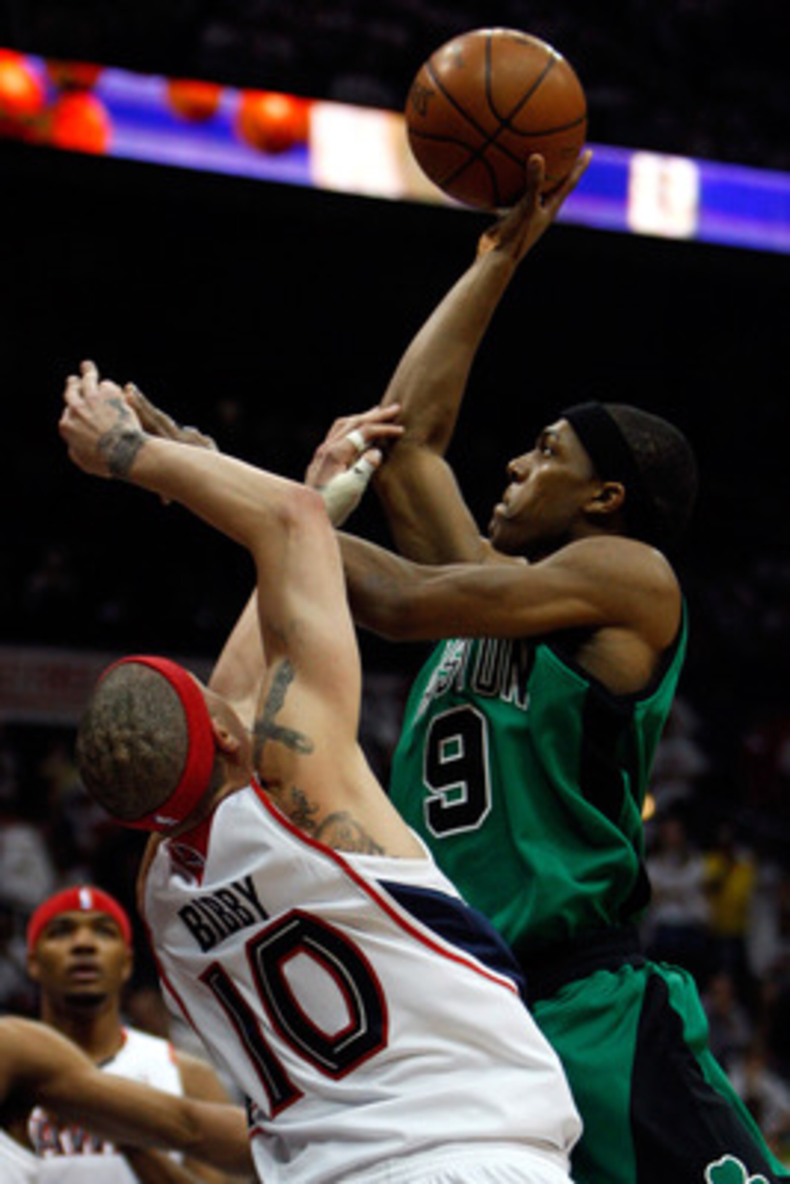 ATLANTA - MAY 02:  Rajon Rondo #9 of the Boston Celtics makes a shot over Mike Bibby #10 of the Atlanta Hawks in Game Six of the Eastern Conference Quarterfinals during the 2008 NBA Playoffs at Phillips Arena on May 2, 2008 in Atlanta Georgia.  NOTE TO US