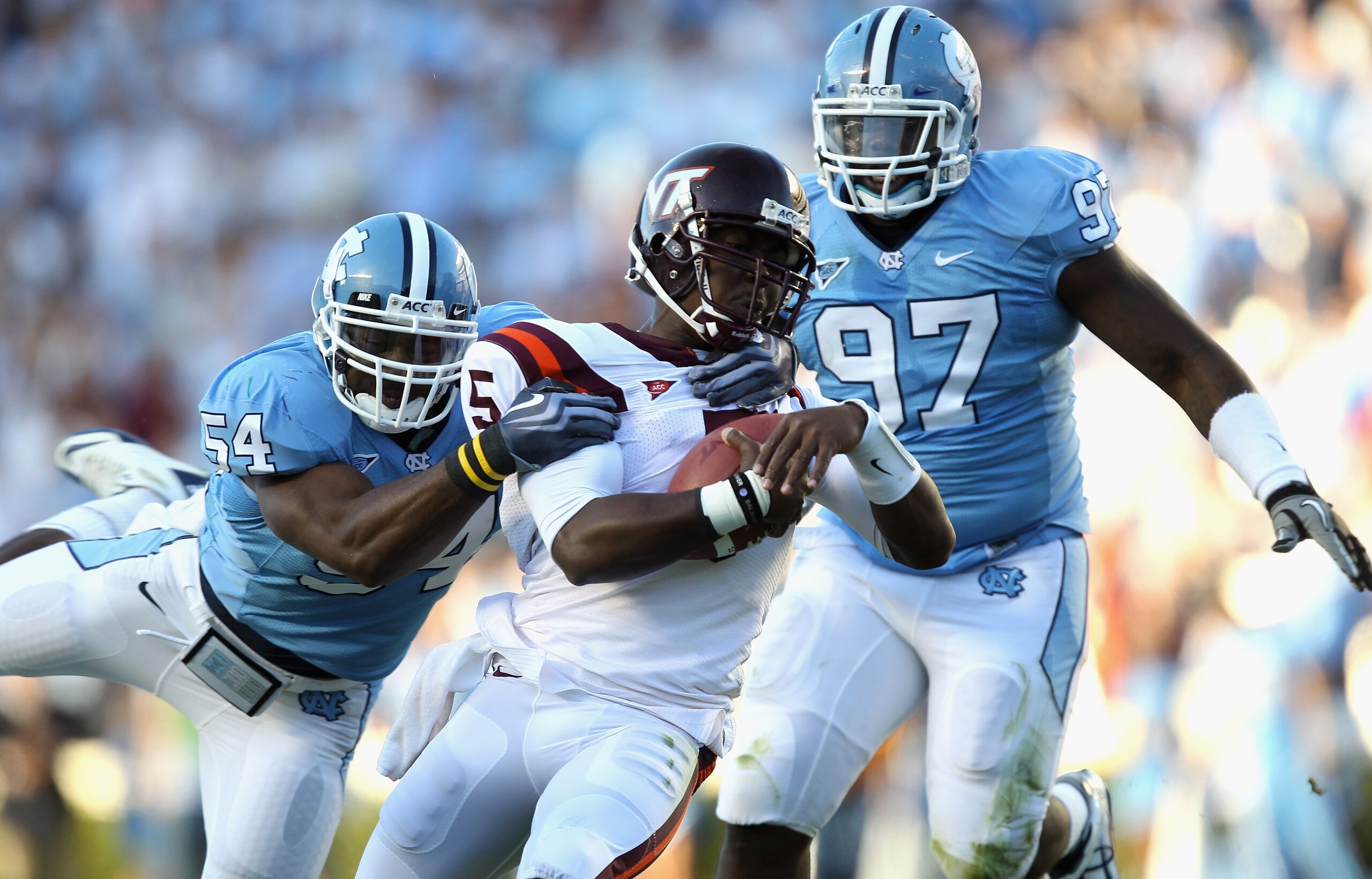 CHAPEL HILL, NC - NOVEMBER 13:  Tyrod Taylor #5 of the Virginia Tech Hokies is tackled by Bruce Carter #54 and teammate Jared McAdoo #97 of the North Carolina Tar Heels during their game at Kenan Stadium on November 13, 2010 in Chapel Hill, North Carolina