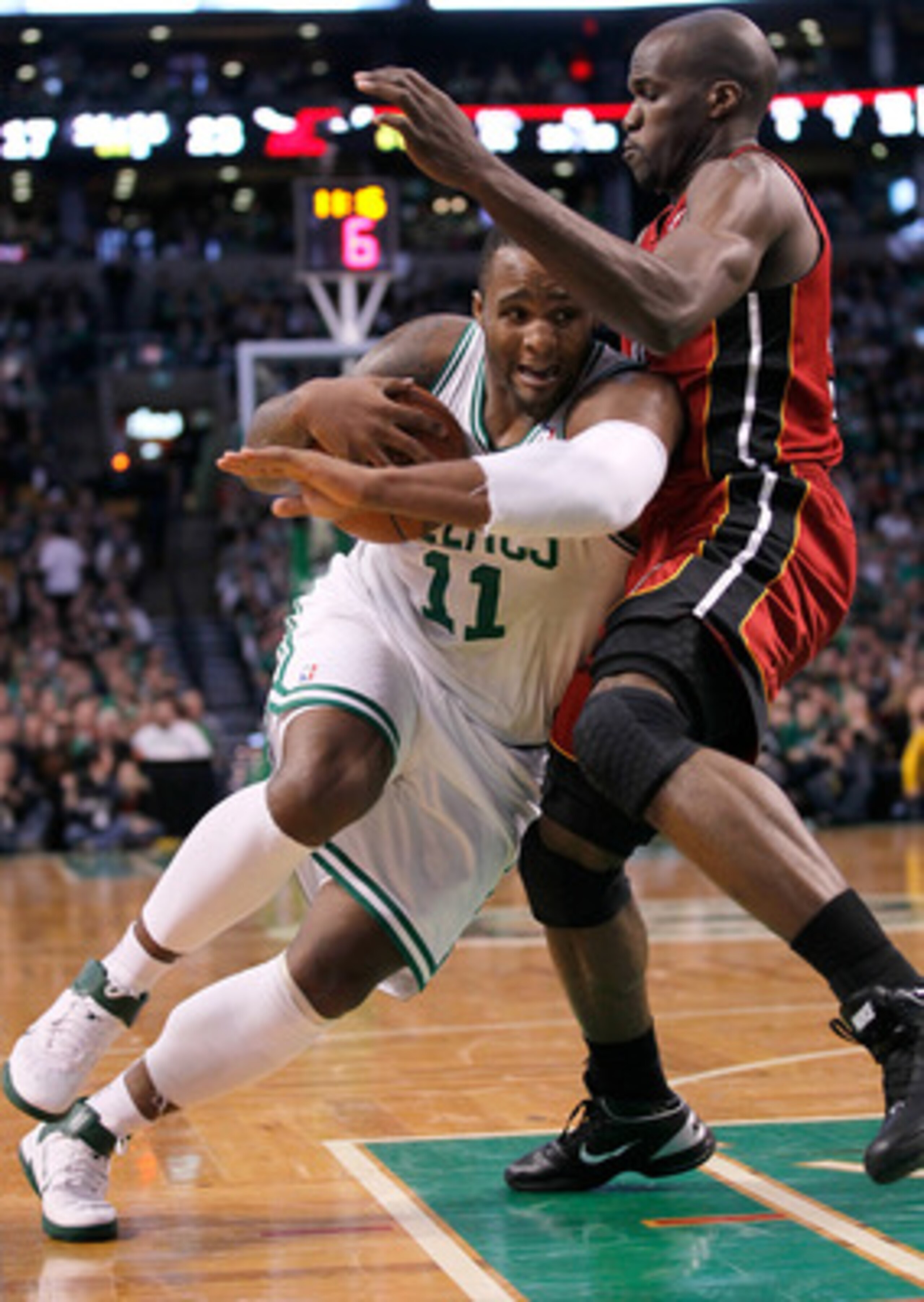 BOSTON - FEBRUARY 13:  Glen Davis #11 of the Boston Celtics drives against Joel Anthony #50 of the Miami Heat at TD Garden on February 13, 2011 in Boston, Massachusetts. The Celtics won 85-82. NOTE TO USER: User expressly acknowledges and agrees that, by 