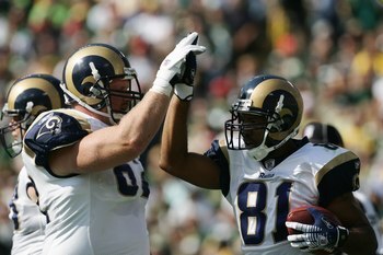 GREEN BAY, WI - OCTOBER 8:  Wide receiver Torry Holt #81 of the St. Louis Rams high fives offensive guard Adam Timmerman #62 during the game against the the Green Bay Packers at Lambeau Field on October 8, 2006 in Green Bay, Wisconsin. The Rams defeated t