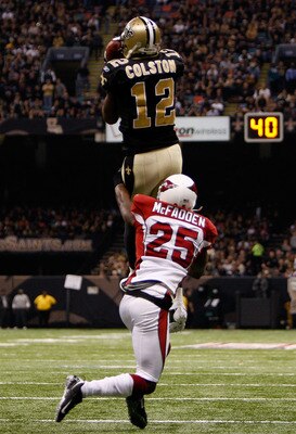 NEW ORLEANS - JANUARY 16:  Marques Colston #12 of the New Orleans Saints makes a reception against Bryant McFadden #25 of the Arizona Cardinals during the NFC Divisional Playoff Game at Louisana Superdome on January 16, 2010 in New Orleans, Louisiana.  (P