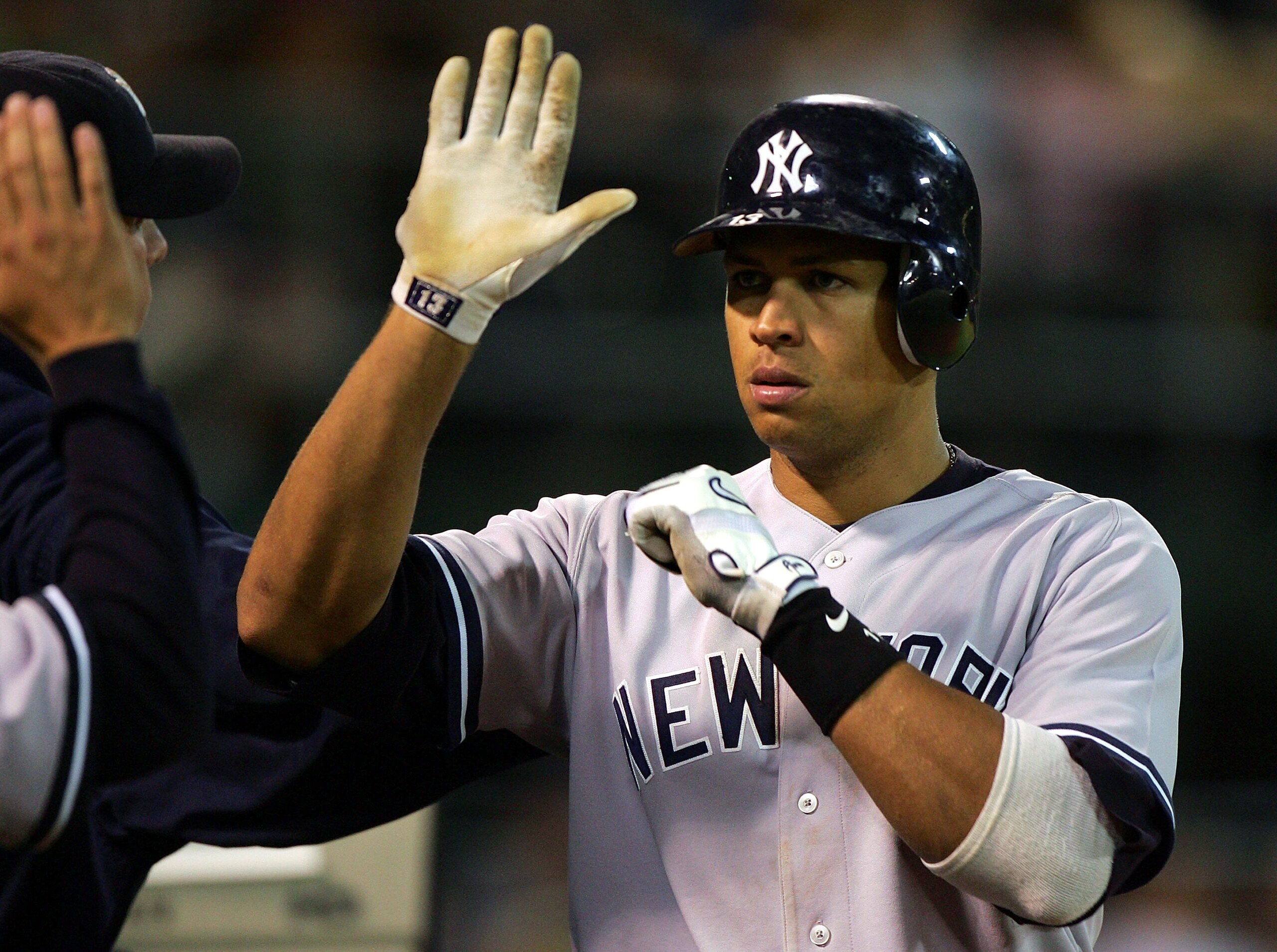 OAKLAND, CA - SEPTEMBER 4: Alex Rodriguez #13 of the New York Yankees is congratulated after scoring in the 8th inning against the Oakland Athletics during a MLB game at McAfee Coliseum on September 4, 2005 in Oakland, California. (Photo by Jed Jacobsoh OAKLAND, CA - SEPTEMBER 4: Alex Rodriguez #13 of the New York Yankees is congratulated after scoring in the 8th inning against the Oakland Athletics during a MLB game at McAfee Coliseum on September 4, 2005 in Oakland, California. (Photo by Jed Jacobsoh